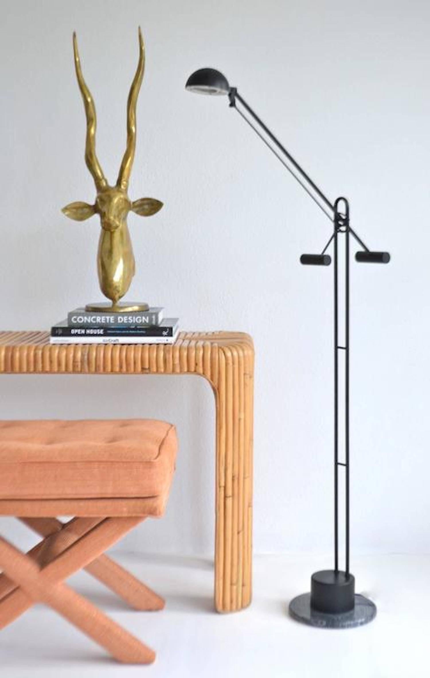 Architectural postmodern articulated crane form floor lamp, circa 1980s. This striking sculptural standing lamp is designed to adjust to cantilevered positions of various heights and angles through a series of mechanical gears and counter weights.