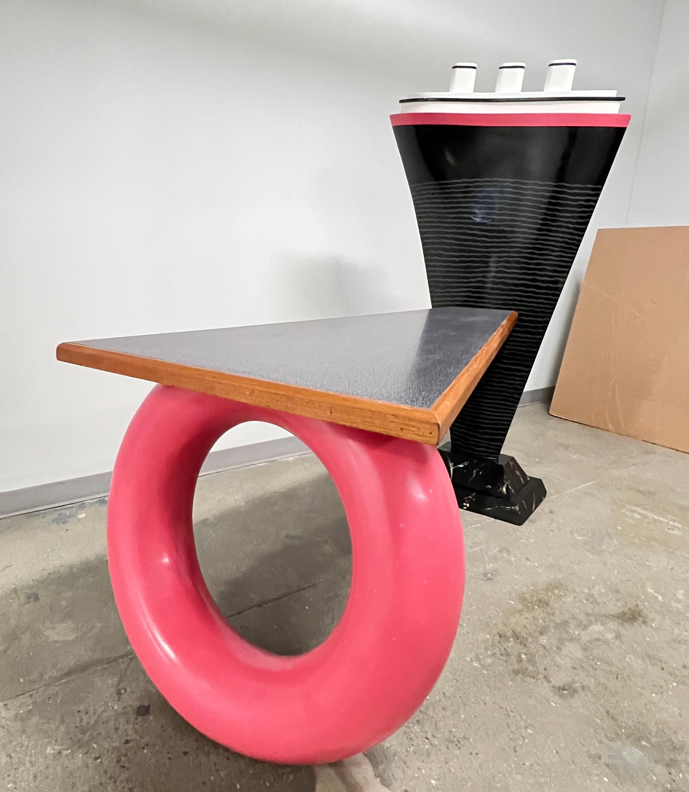 One-of-a-kind postmodern desk, made during the Art Furniture Movement of the 1980s by Tim Curtis of St. Louis, MO. It features a whimsically tall cruise ship upon a faux marbled base docked alongside a wedge shaped “wharf’. A jauntily colorful “life