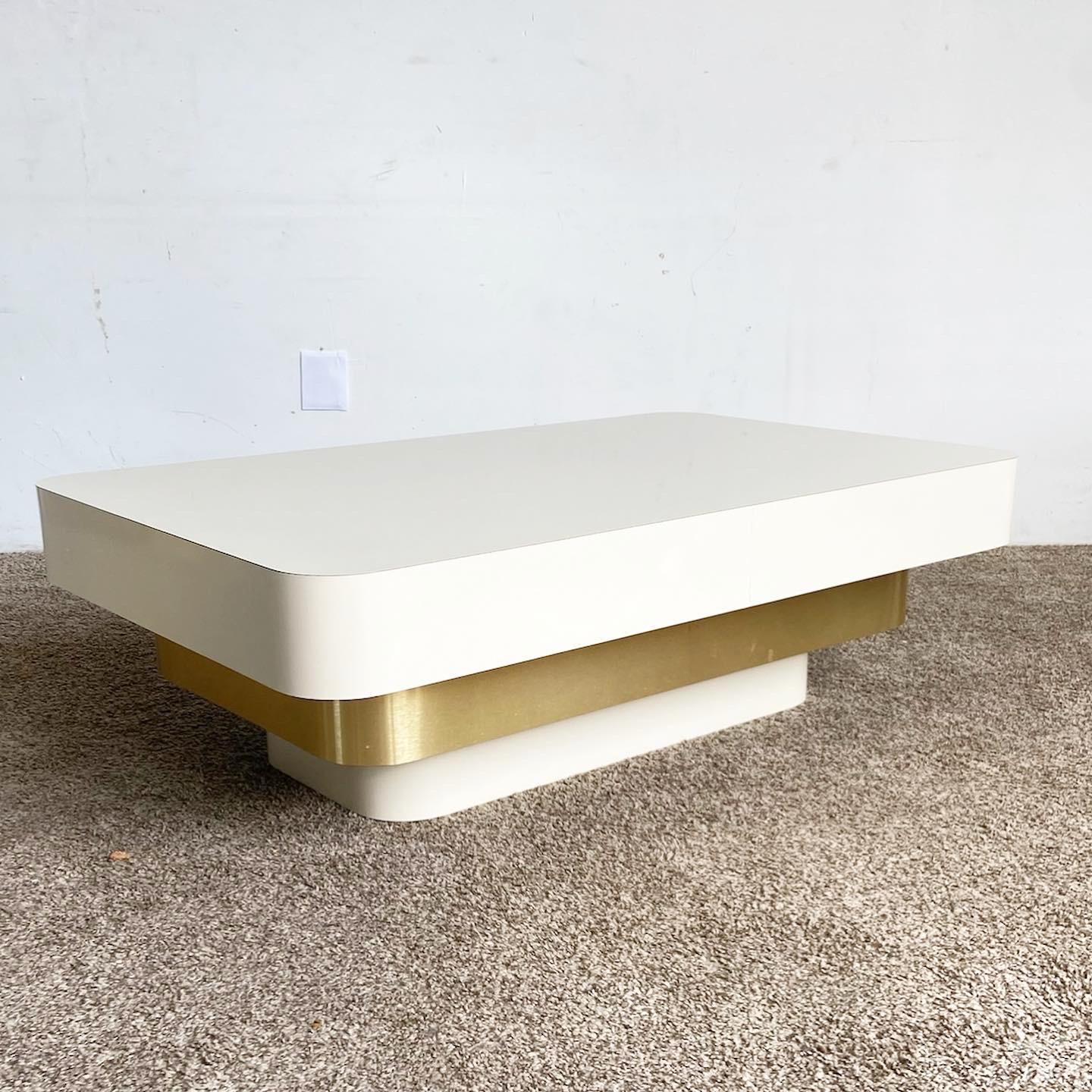 Enhance your living room with our Ascending Cream and Gold Coffee Table, featuring a unique tri-layer design that blends postmodern style with practicality.

Unique tri-layer design with top and bottom layers in sleek cream lacquer finish.
Bold gold