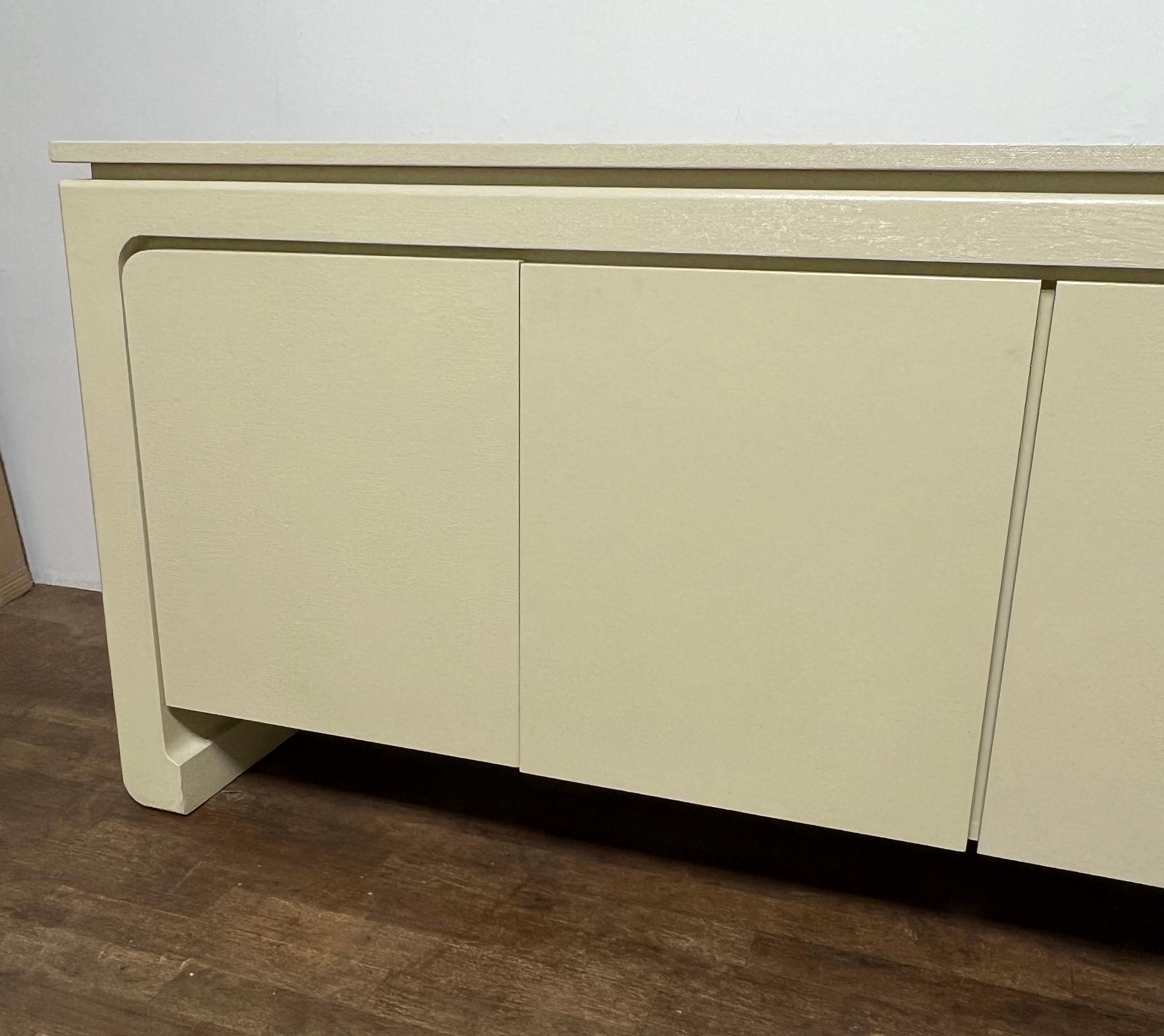  Postmodern Asian inspired credenza in ivory lacquered grasscloth, ca. 1980s, in the manner of Karl Springer.