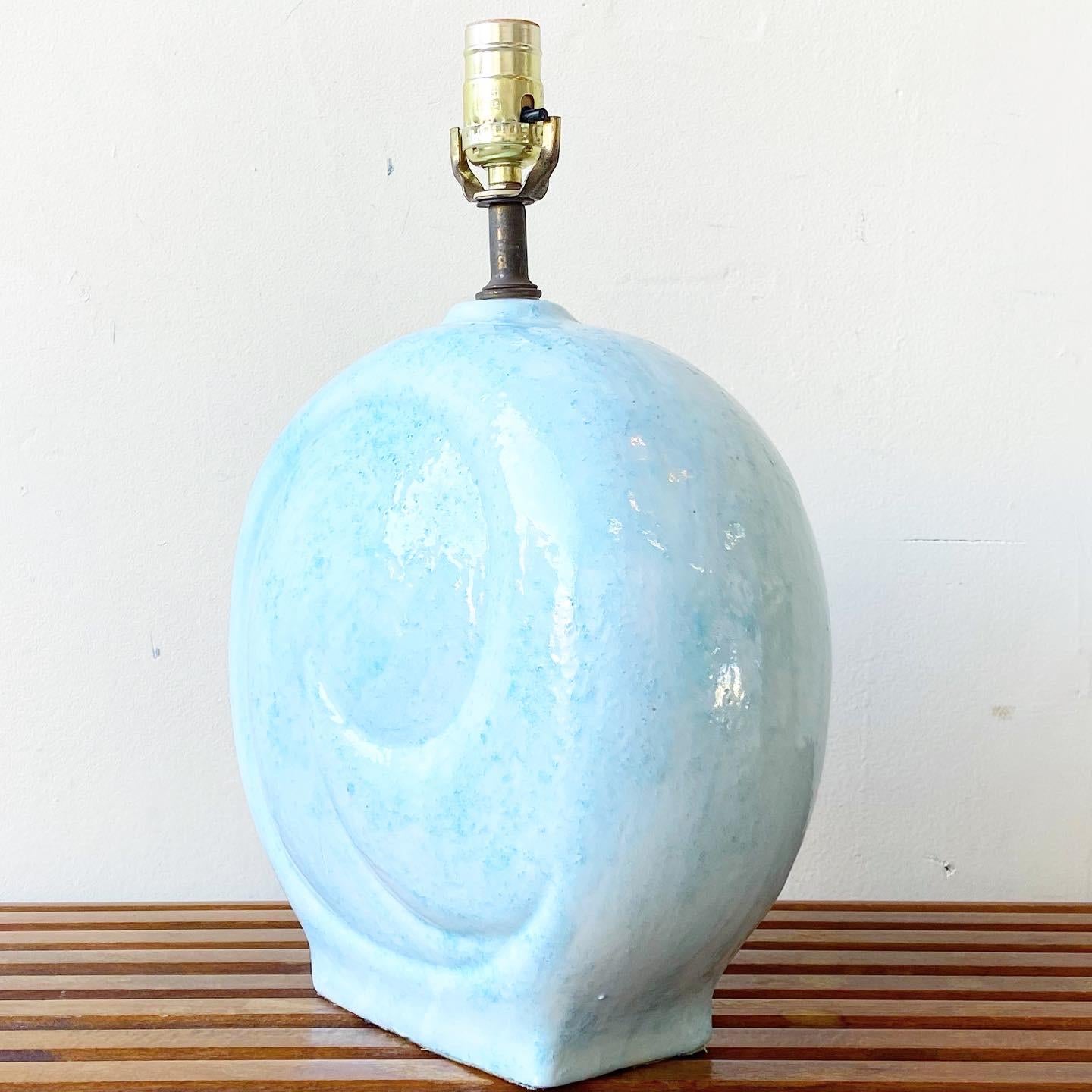 Incredible ceramic table lamp. Displays a beautiful baby blue sculpted circular swirl shape.

Additional information:
Material: Ceramic
Color: Blue
Style: Postmodern
Time Period: 
Place of origin: USA
Dimension: 9