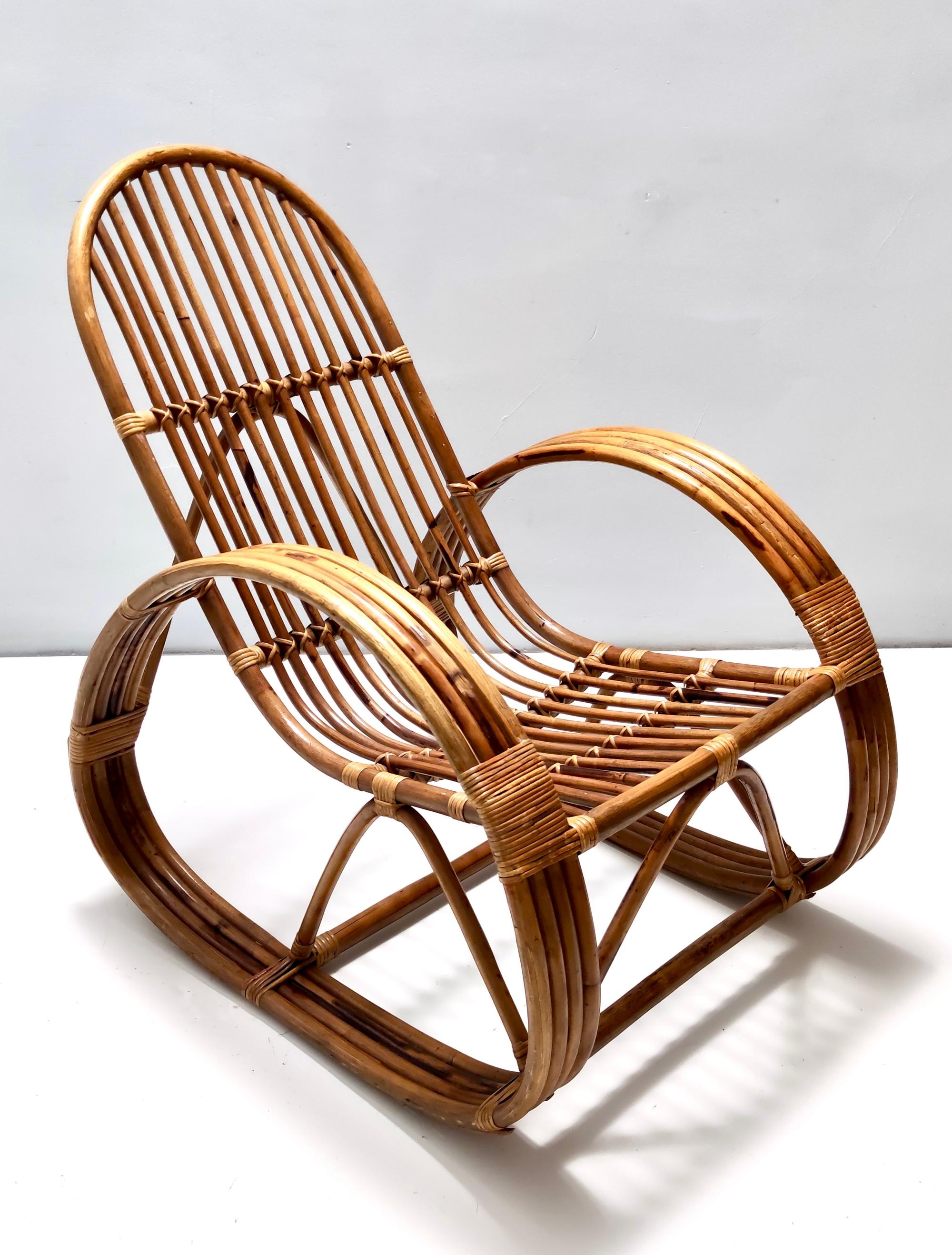 Made in Italy, 1970s. 
This rocking chair features a bamboo frame and its patterned fabric cushion, which has a soft padding and has no stains or flaws.
It is vintage, therefore it might show slight traces of use, but it can be considered as in very