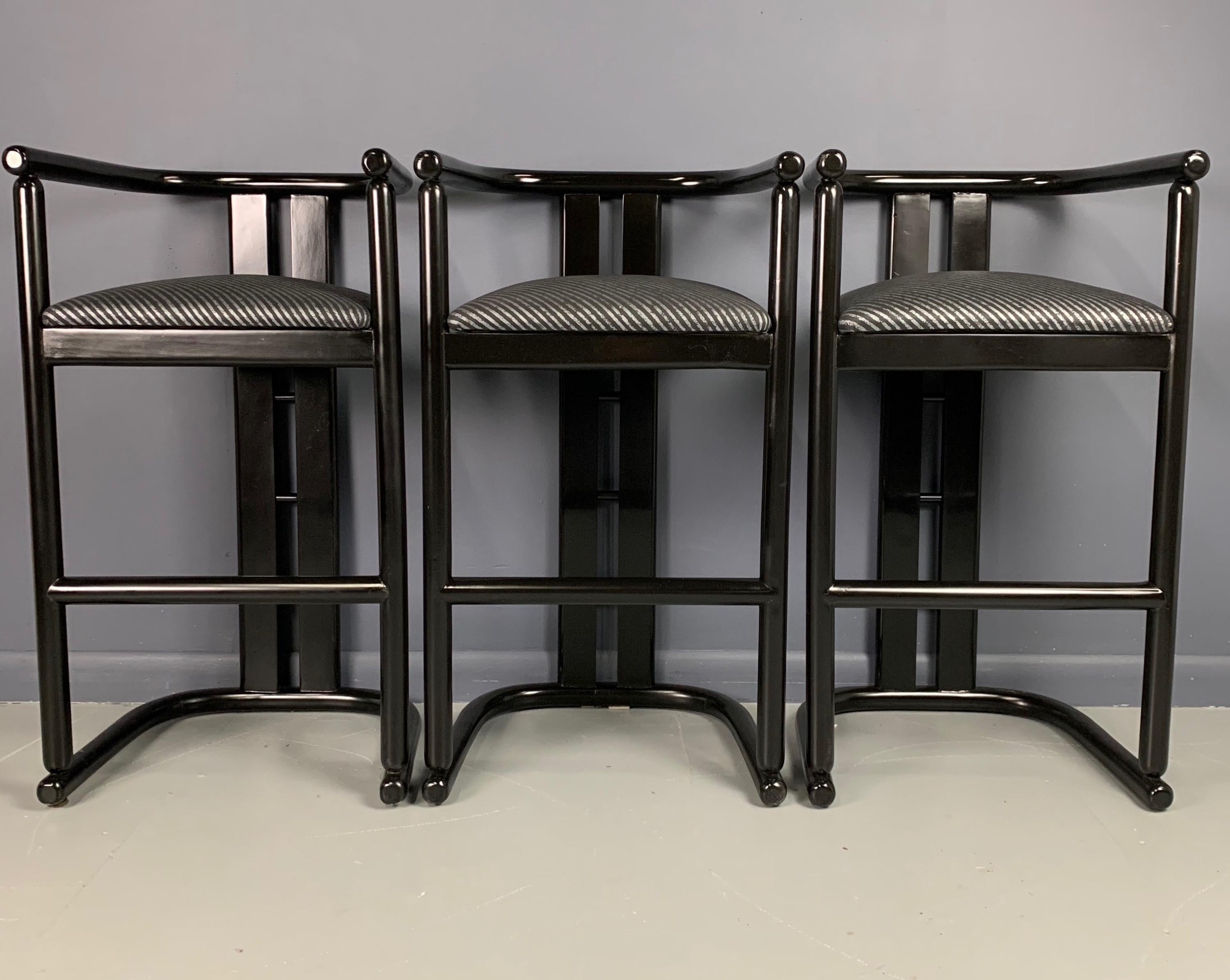 Three barrel back barstools from the 1990s in black lacquer with period upholstery. These stools have a design reminiscent of Pierre Cardin.