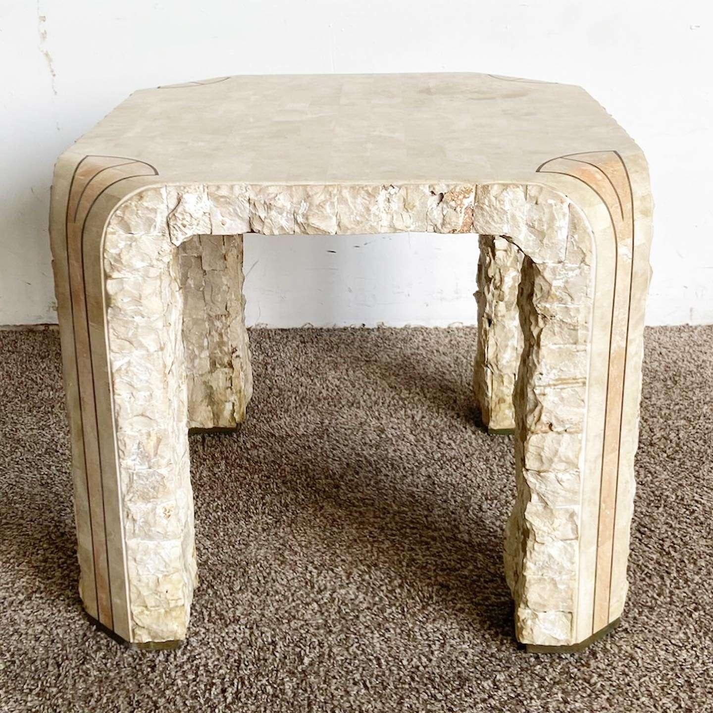 Add a touch of vintage postmodern charm to your space with this wonderful tessellated stone side table. The table features brass inlays on the feet and bordering the pink and beige stone, creating a stylish and unique design.

Vintage postmodern