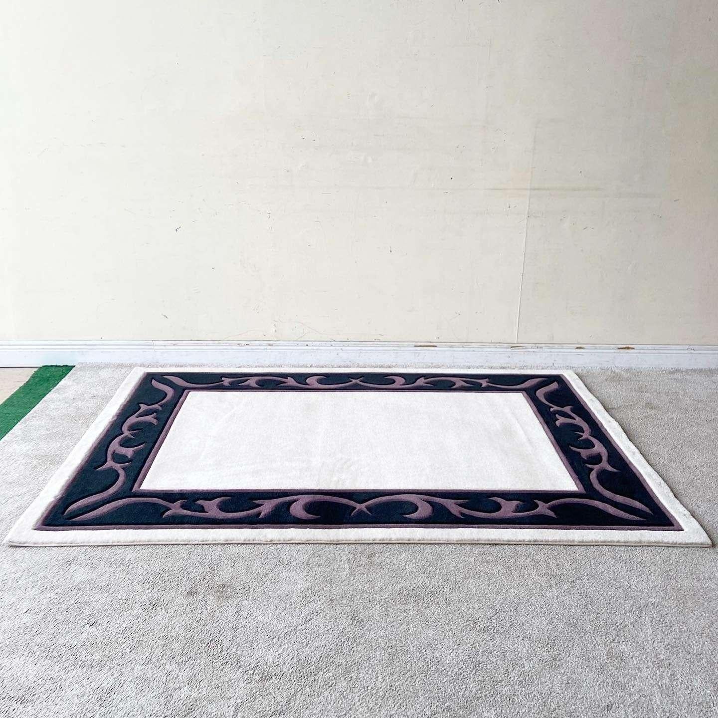 Exceptional vintage postmodern rectangular area rug. Features a beige interior border by a black section with purple vining throughout the edge.

Rug 11
