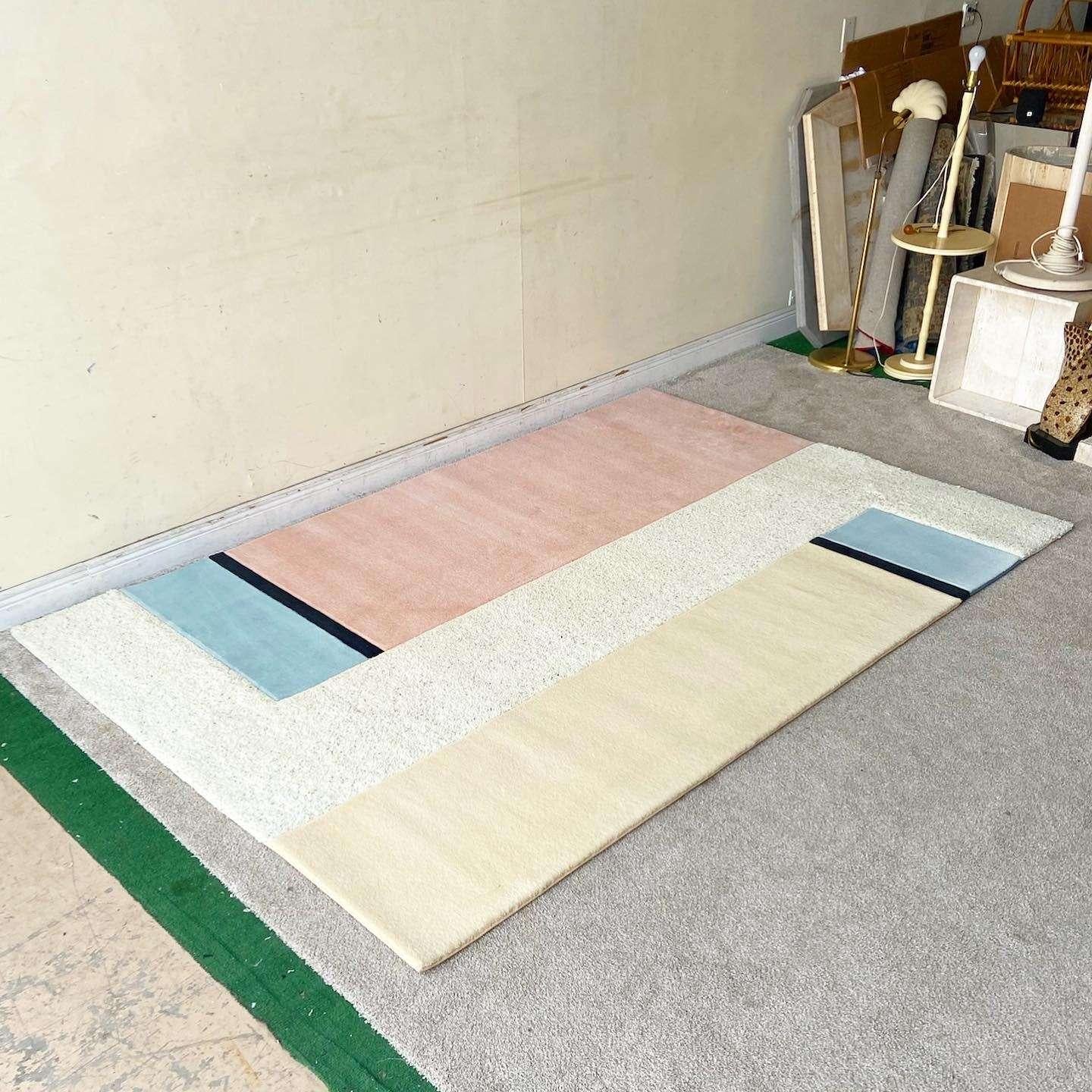 Amazing vintage postmodern rectangular area rug. The carpet is comprised of beige, pink, blue and black rectangles with a shaggy beige center.

Rug 25
