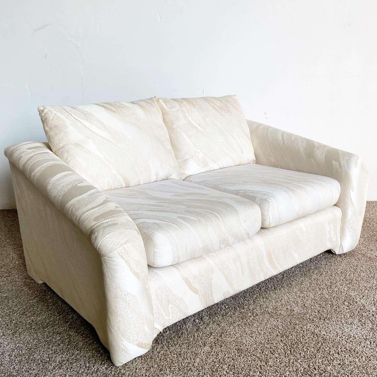 Exceptional vintage postmodern sculpted love seat. Features a beige textured fabric throughout.
