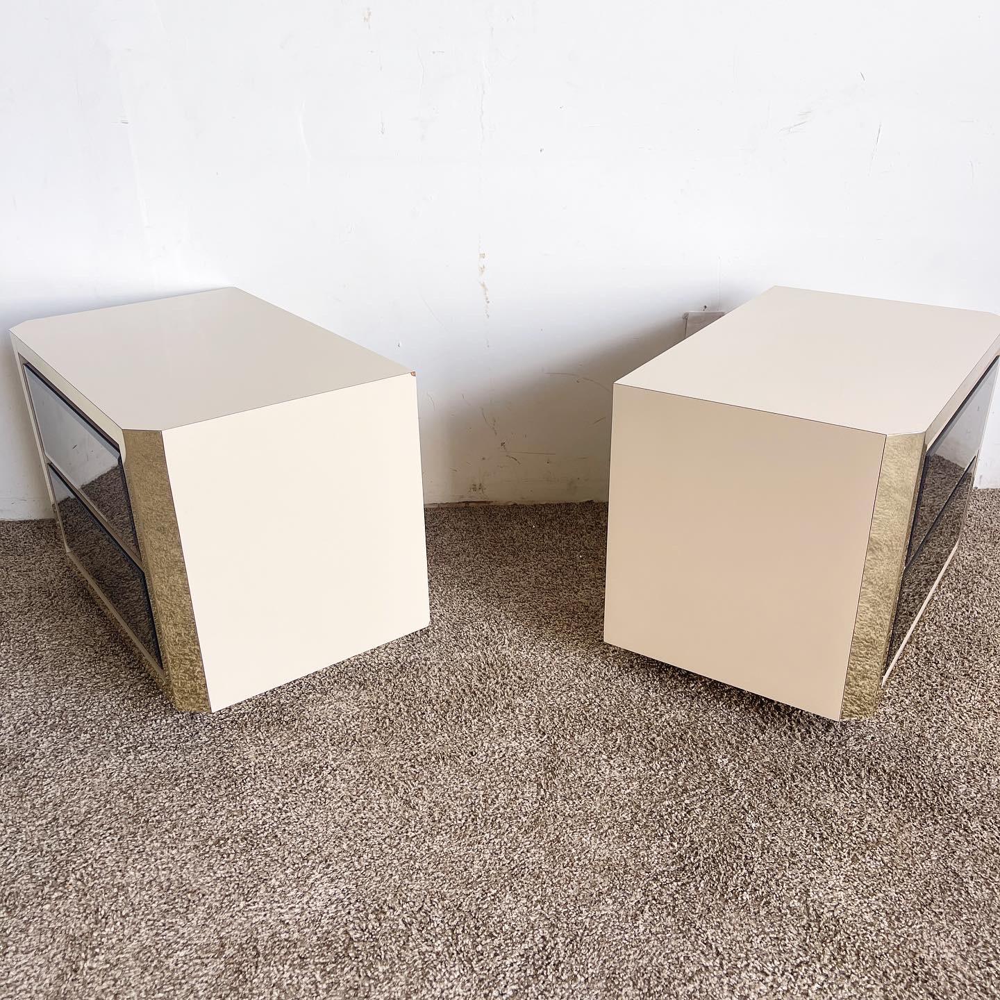 Upgrade your bedroom decor with our stunning Vintage Postmodern Nightstands. These nightstands, featuring smoked beveled mirror drawers, gold paneling, and a beige lacquer laminate finish, offer a fusion of elegance and practicality. Ideal for