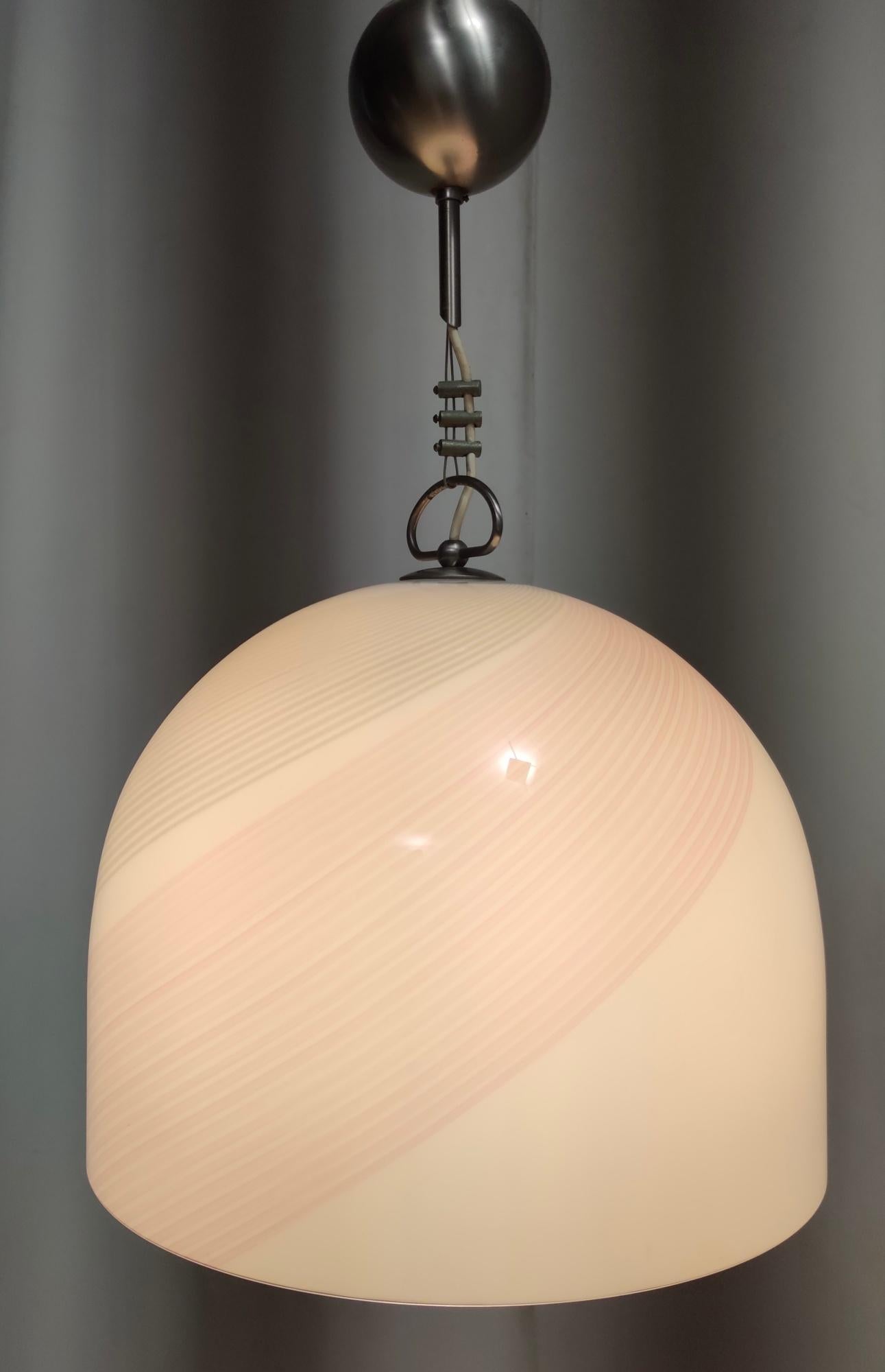 Made in Italy, 1970s - 1980s. 
It features a bell-shaped white Murano glass lampshade with pink and grey lines. 
This pendant is a vintage piece, therefore it might show slight traces of use, but it can be considered as in excellent original
