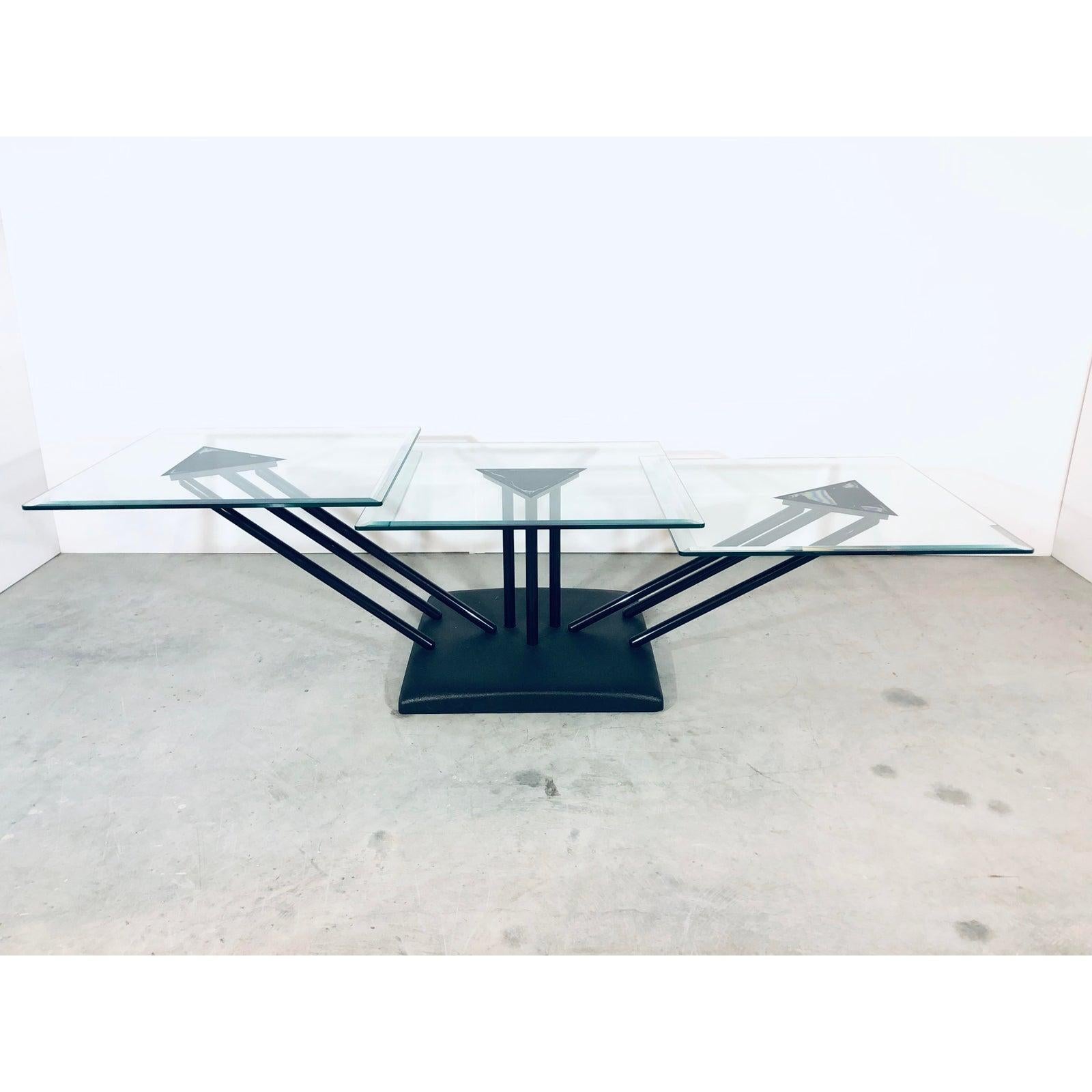 Glass and steel adjustable coffee or cocktail table. The tables are set about 1 inch apart in height and can be adjusted side to side. Bellato, 1980s.