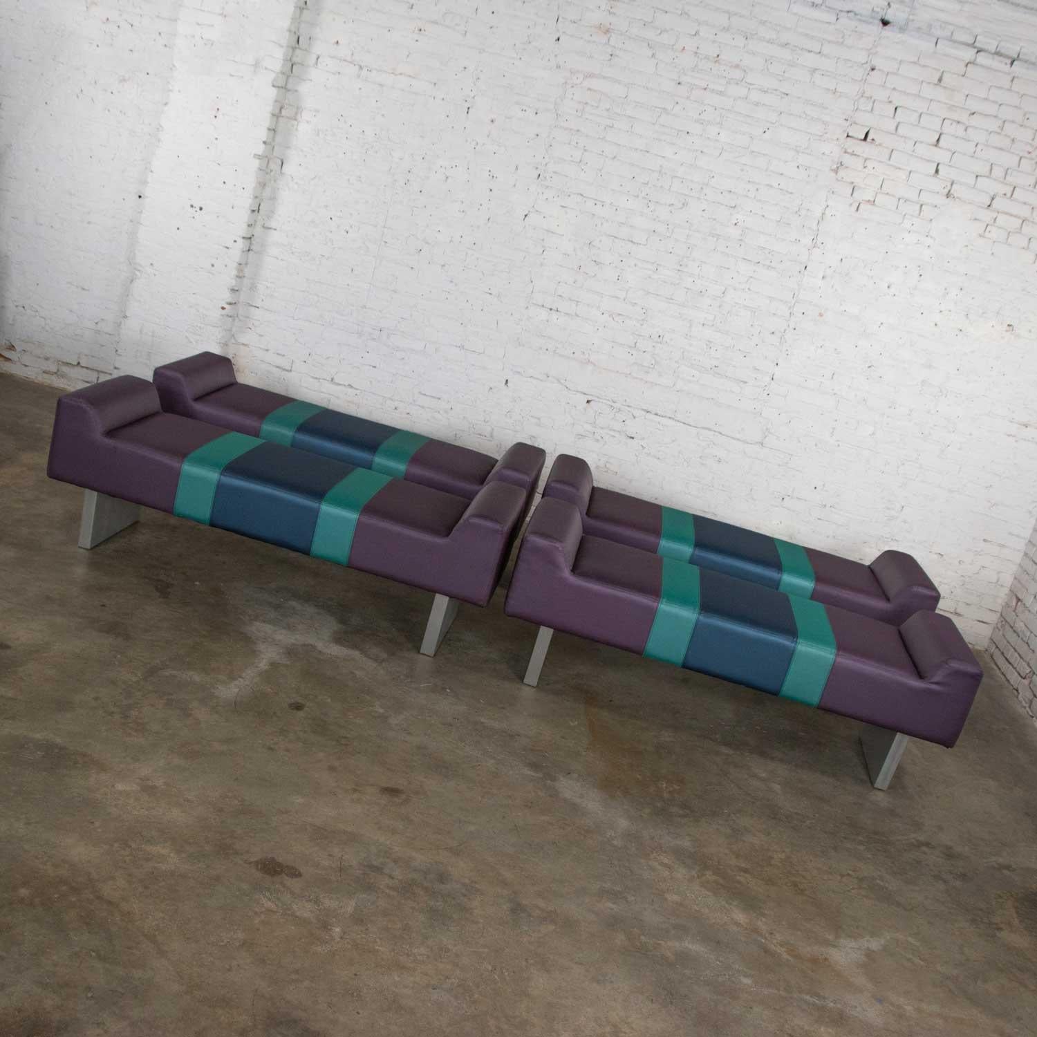 Gorgeous postmodern benches reminiscent of The Memphis Group. Comprised of purple vinyl upholstered foam cushions with turquoise and blue center stripe and extruded brushed aluminum base. There are a couple of small holes on two of the benches that