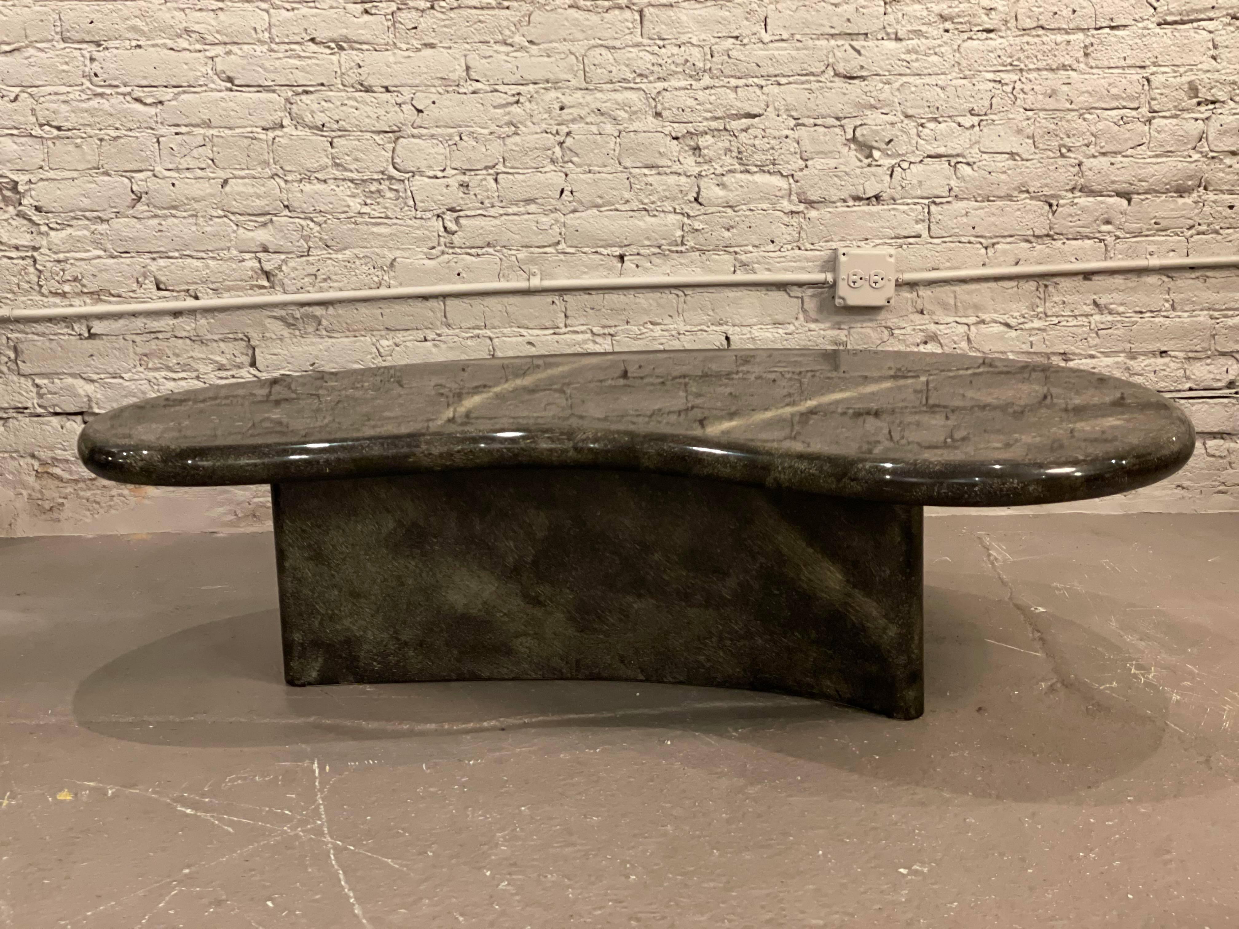 Super cool curved coffee table. The colors range from black, brown, to beige. The coating is lacquer and the pattern almost has an animal print or stone pattern. It’s very neutral with a lot of personality!

Dimensions: 60