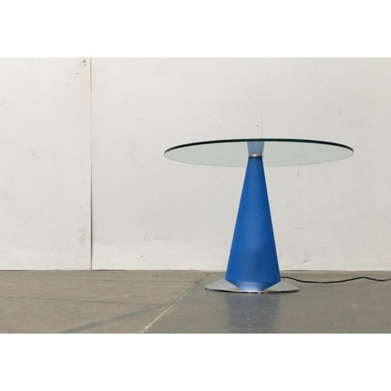 Postmodern side table with lighting by the Italian manufacturer Fontana Arte, designed by Parisotto from the 80s. A rare piece and hard to find.

The design follows a post-modern design language of clear geometry. A round glass rests on a central