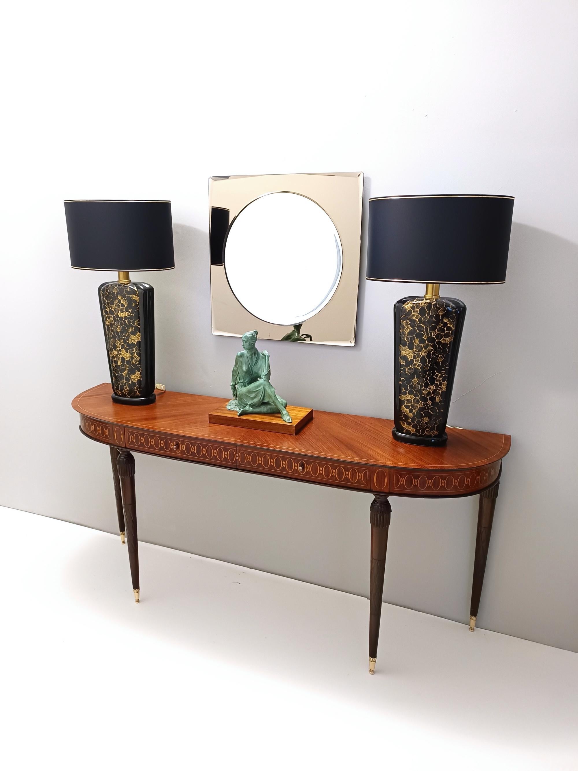 Made in Italy, 1980s.
These table lamps are made in black and gold glazed ceramic and brass. 
They are vintage items, therefore they might show slight traces of use, but they can be considered as in excellent original condition and ready to give