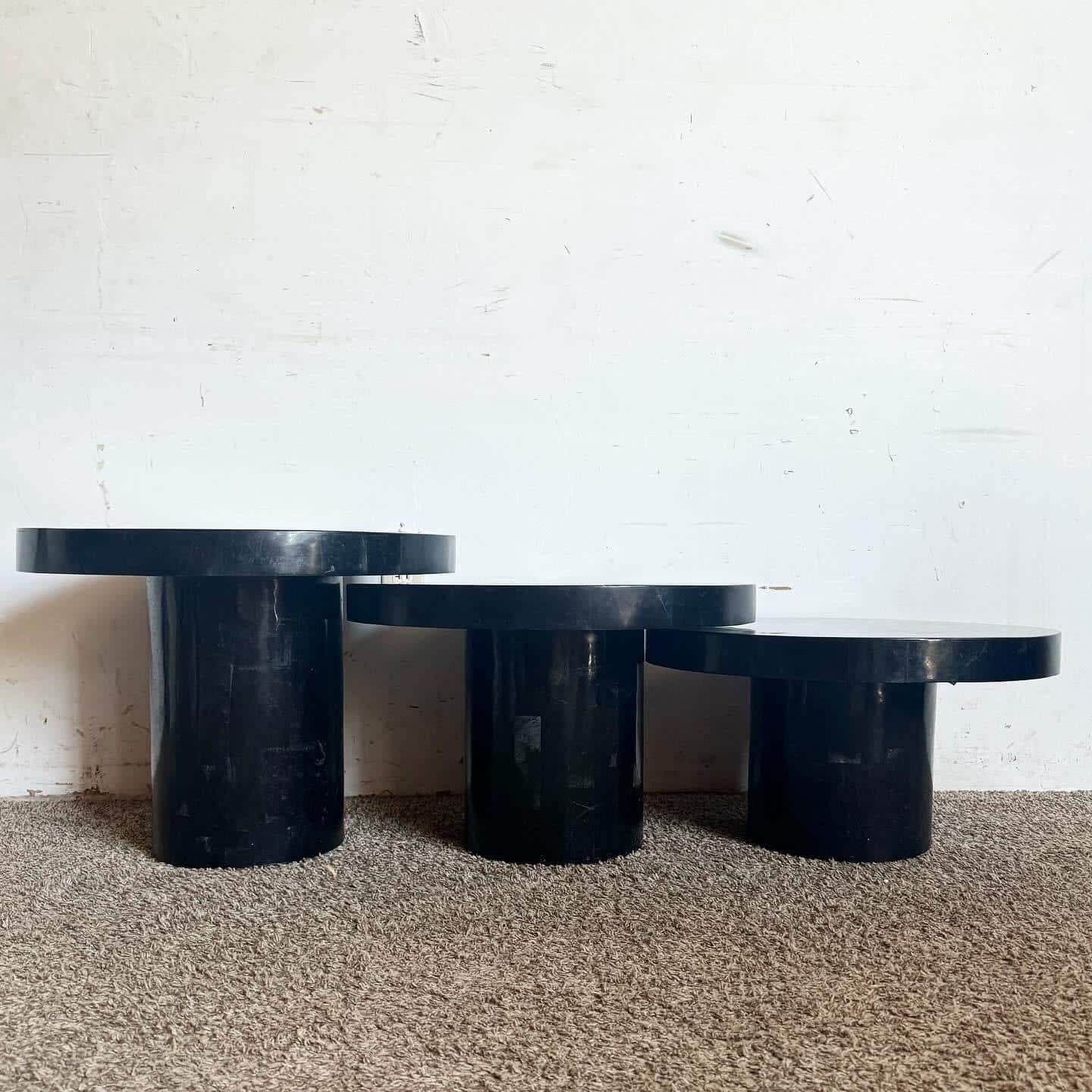 Elevate your home decor with the sophisticated elegance of the Marquis Collection of Beverly Hills Postmodern Black and Grey Tessellated Stone Circular Mushroom Nesting Tables. Each table features a sleek black tessellated stone finish, accented by