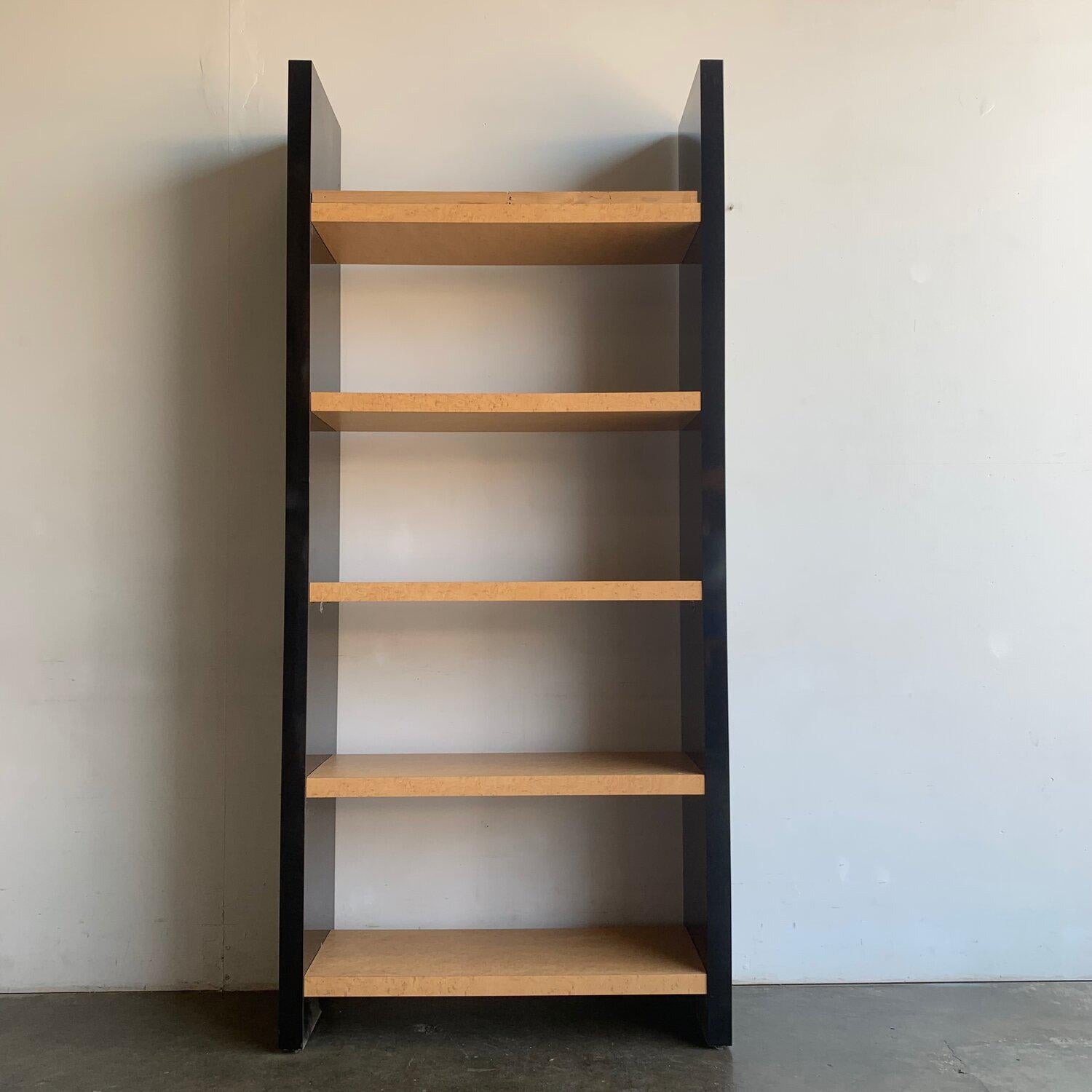Measures: W36, D14, H80.

Very well preserved stationary shelving bookcase in black lacquer laminate and yellow maple laminate interior. Item has a support upper wooden bar that is used to secure bookshelf against wall for great stability. (See