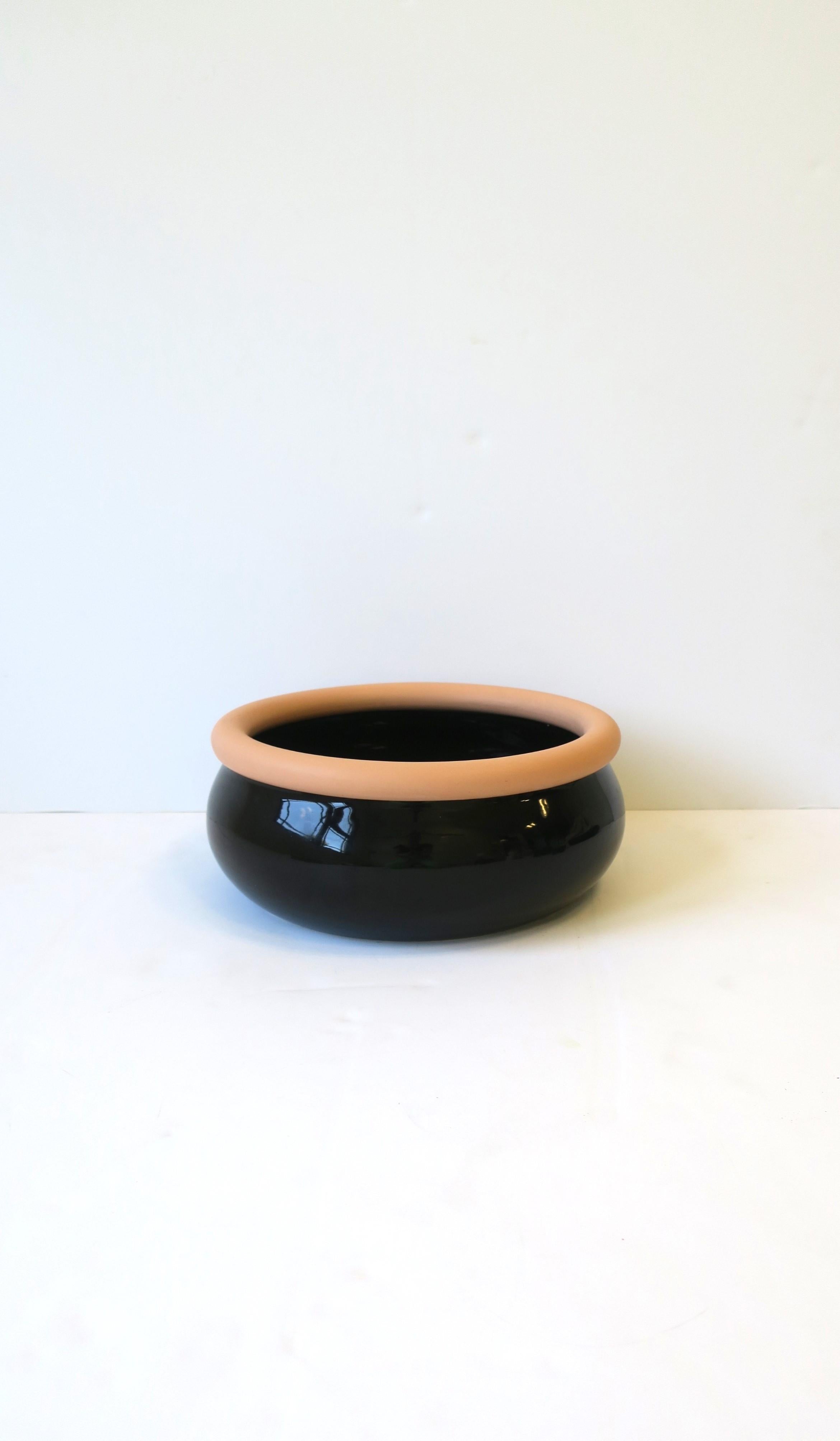 A beautiful black ceramic and terracotta bowl, Postmodern design period, circa late-20th century, 1980s, 1990s. Made in Portugal. Bowl has a black glazed ceramic exterior/interior and an unglazed terracotta pottery lip. A beautiful piece that