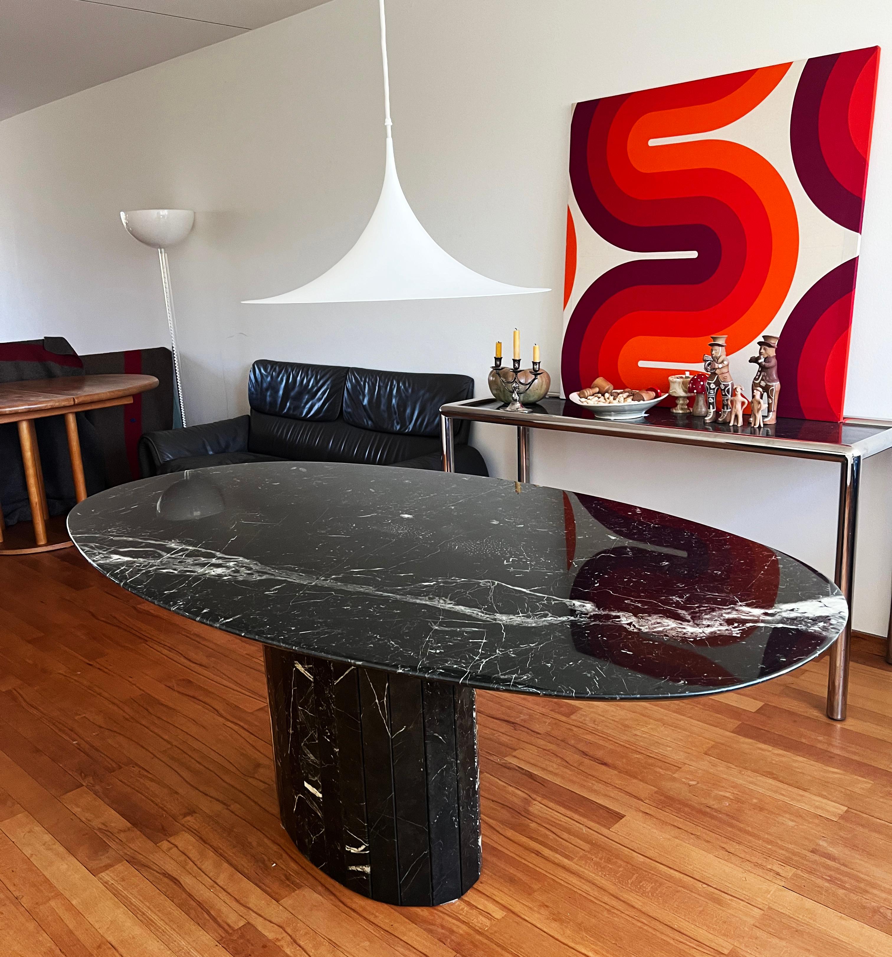 Stunning, beautifully veined post modern Solid substantial Italian marble dining table. Beautiful Oval table top shape with an Iconic base and an overall beautiful minimalistic, geometric shape! Beveled edges, and smooth wonderful marble grained