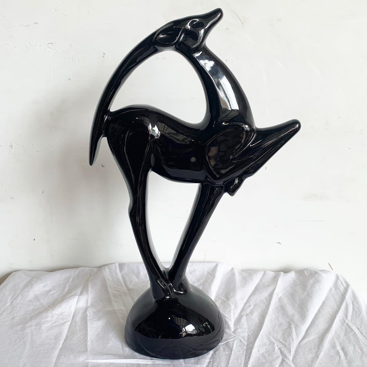 Elevate your decor with the Haeger Ibex Ceramic Sculpture. Crafted in deep black ceramic, this piece captures the majesty of the Ibex with a contemporary twist. Haeger's meticulous craftsmanship is evident in the sculpture's precise detailing and