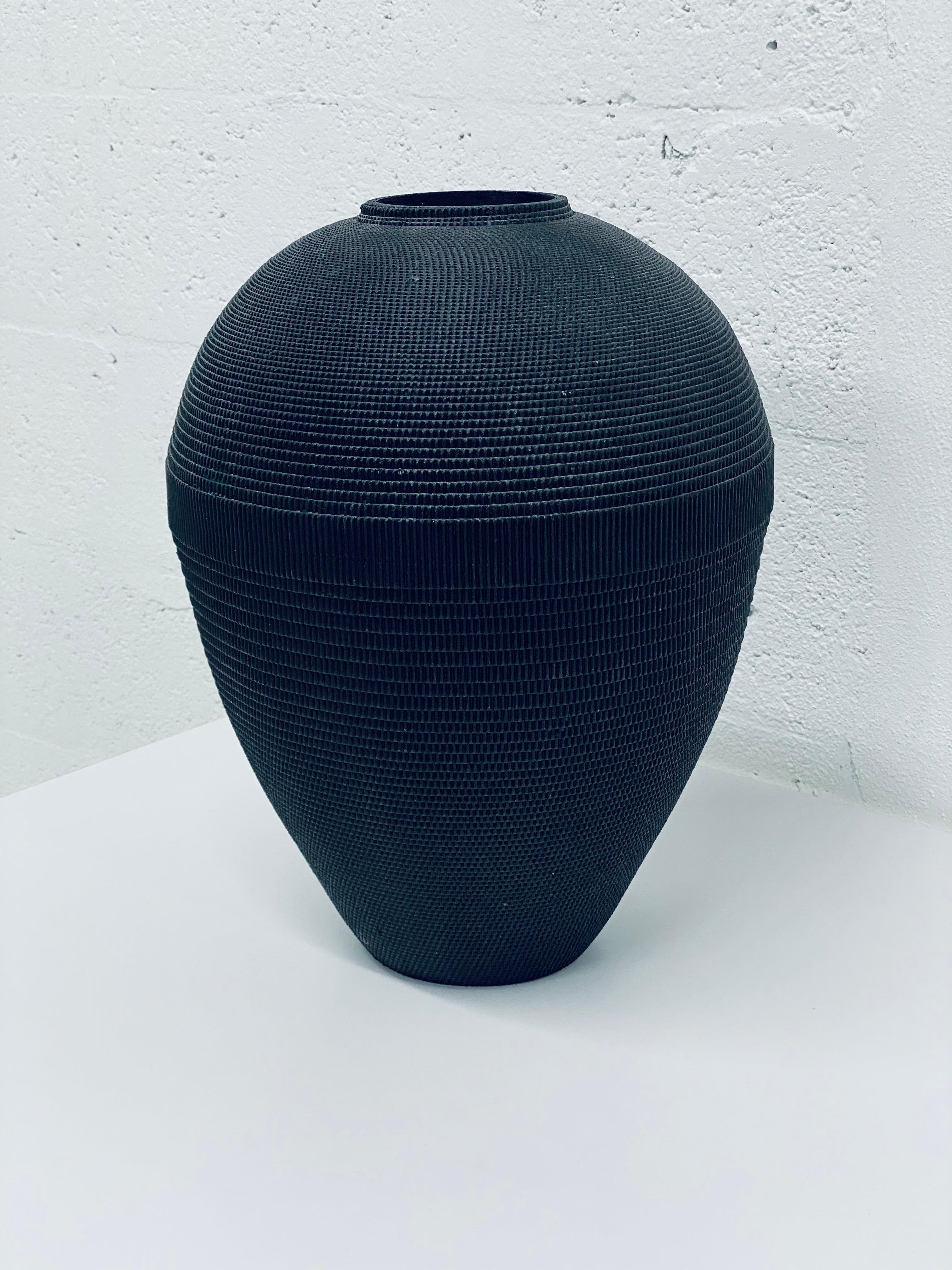 Corrugated cardboard vase rendered in matte black by Flute, Chicago circa 1980s. Best to use with dried arrangements.