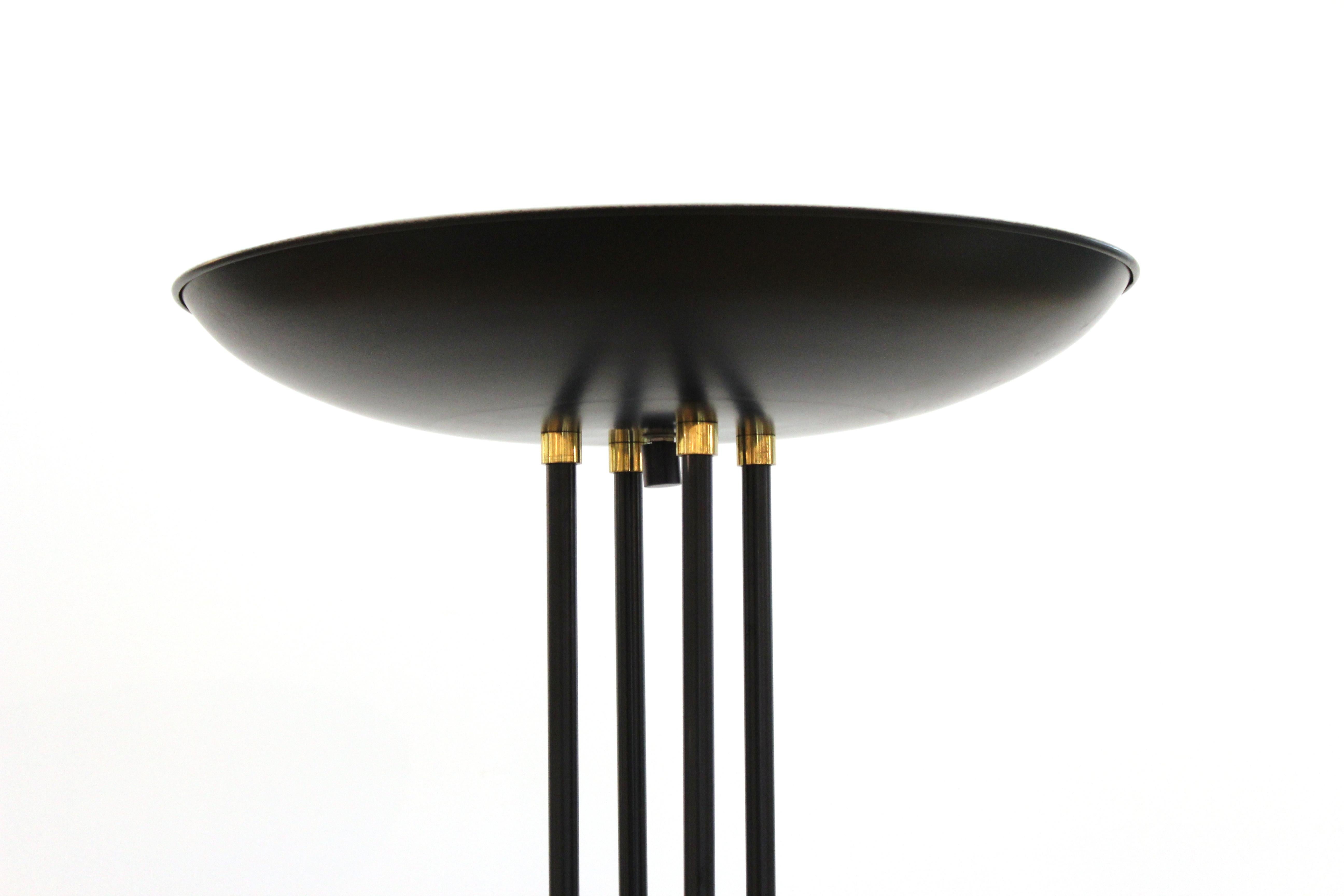 Postmodern black enameled metal halogen floor lamp / torchiere, with tubular rods supporting saucer shade with brass detail. Measures: 70.5