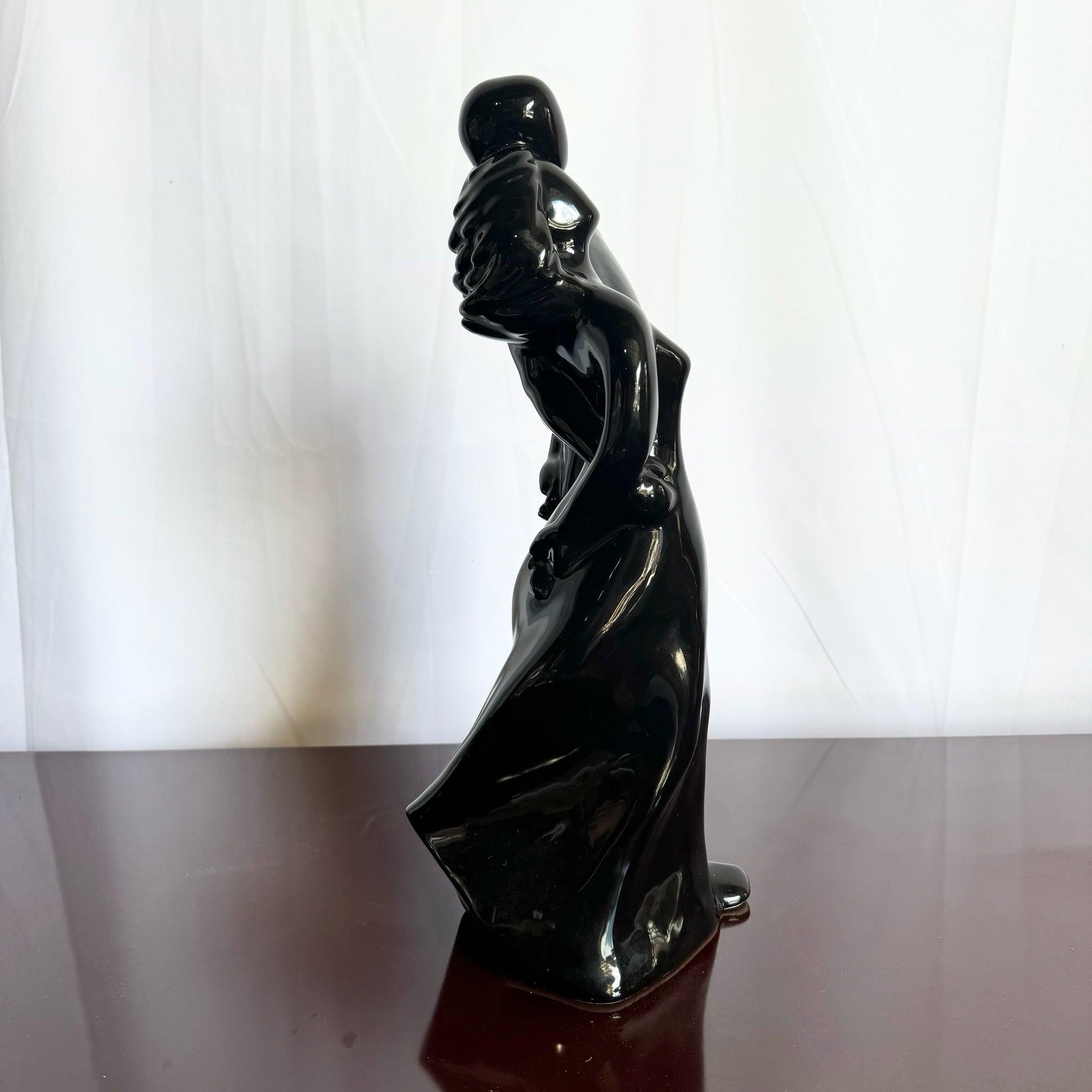 Postmodern Black Glass Male and Female Haeger Sculpture featuring abstract figures in a high-gloss finish, capturing fluidity and intimacy.
 
 We sell items as acquired, without restoring or repairing. Vintage pieces may have age-related wear.