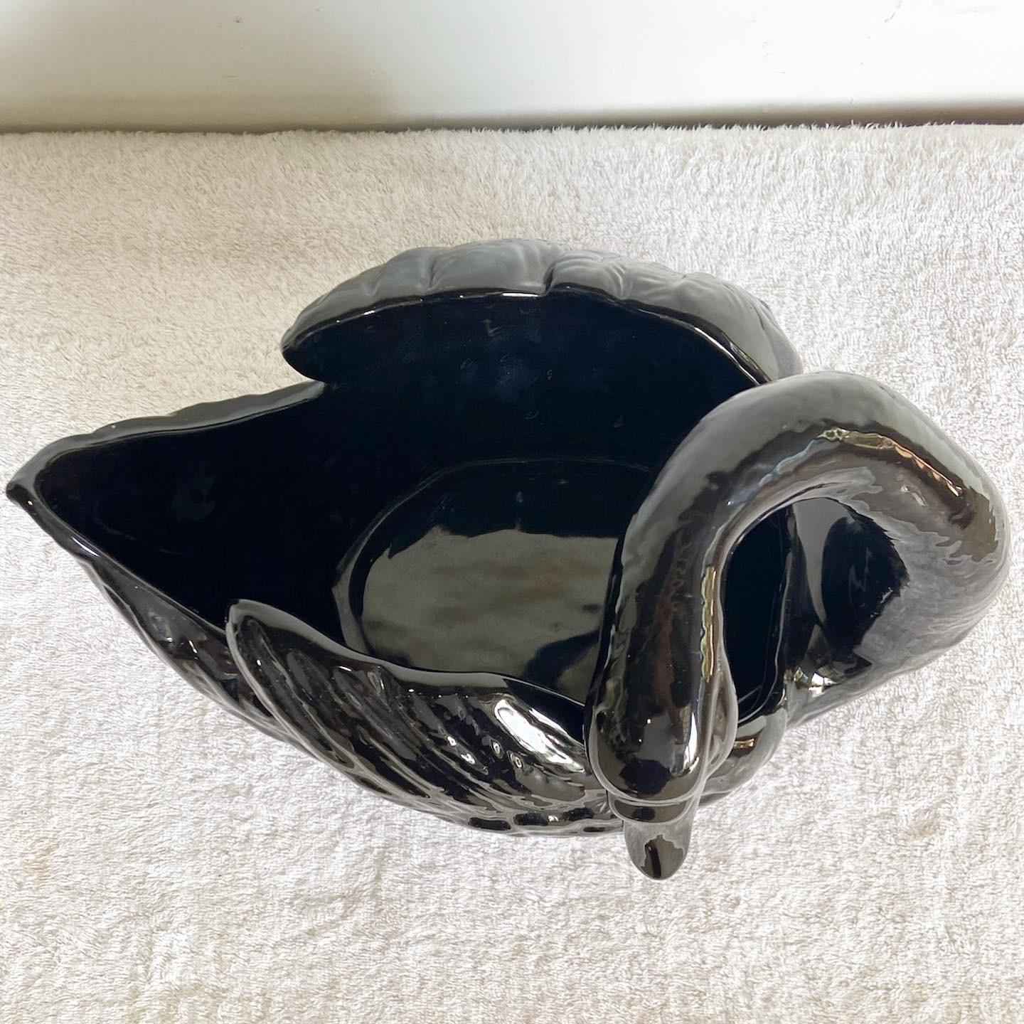 Enhance your decor with our Vintage Postmodern Ceramic Swan Dish. Its sleek black gloss finish makes this piece not only a stylish accessory, but also a functional addition to your home, perfect for those seeking a touch of vintage