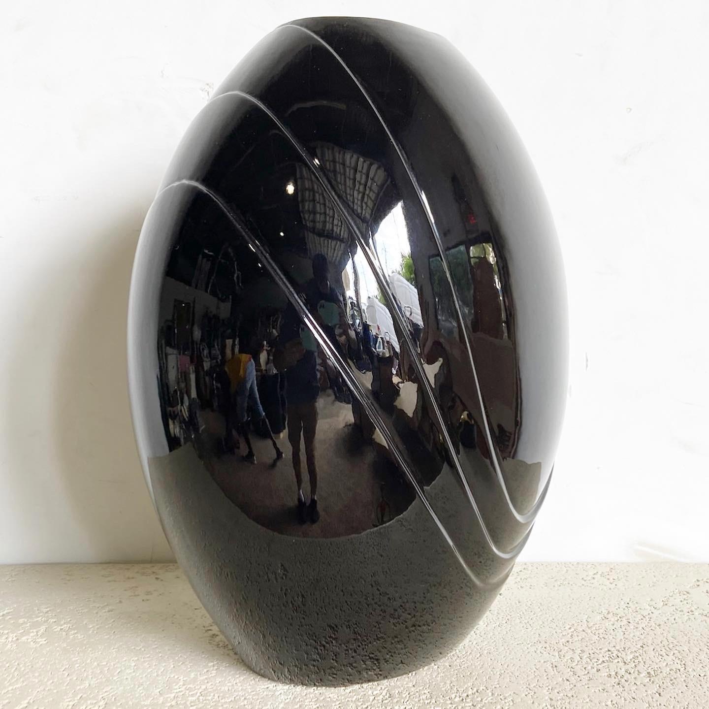Immerse in the allure of postmodern design with this Black Gloss Vase by Haeger. With its captivating gloss finish and angular form, this vase is more than just a container‚Äîit's a statement piece.
Vintage pieces may have age-related wear. Review