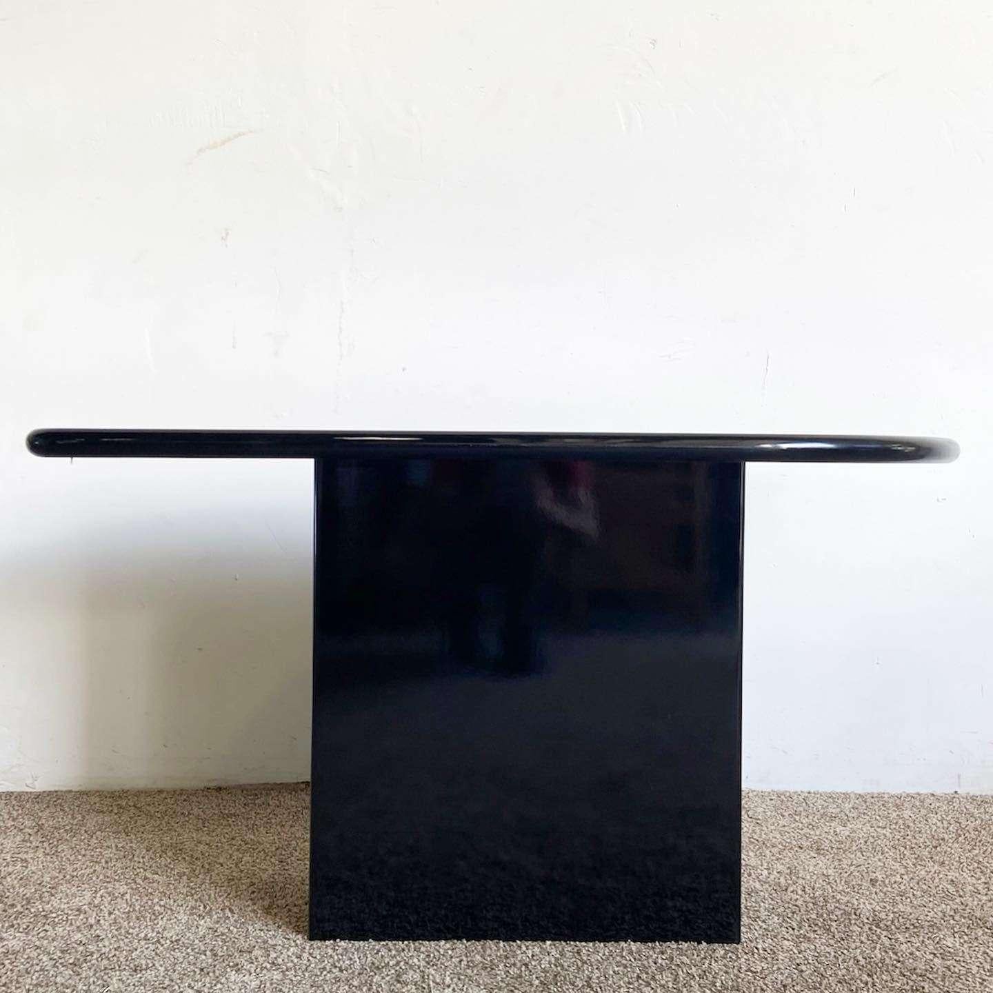 Wonderful vintage postmodern console table. Features a black finish throughout the surfaces.