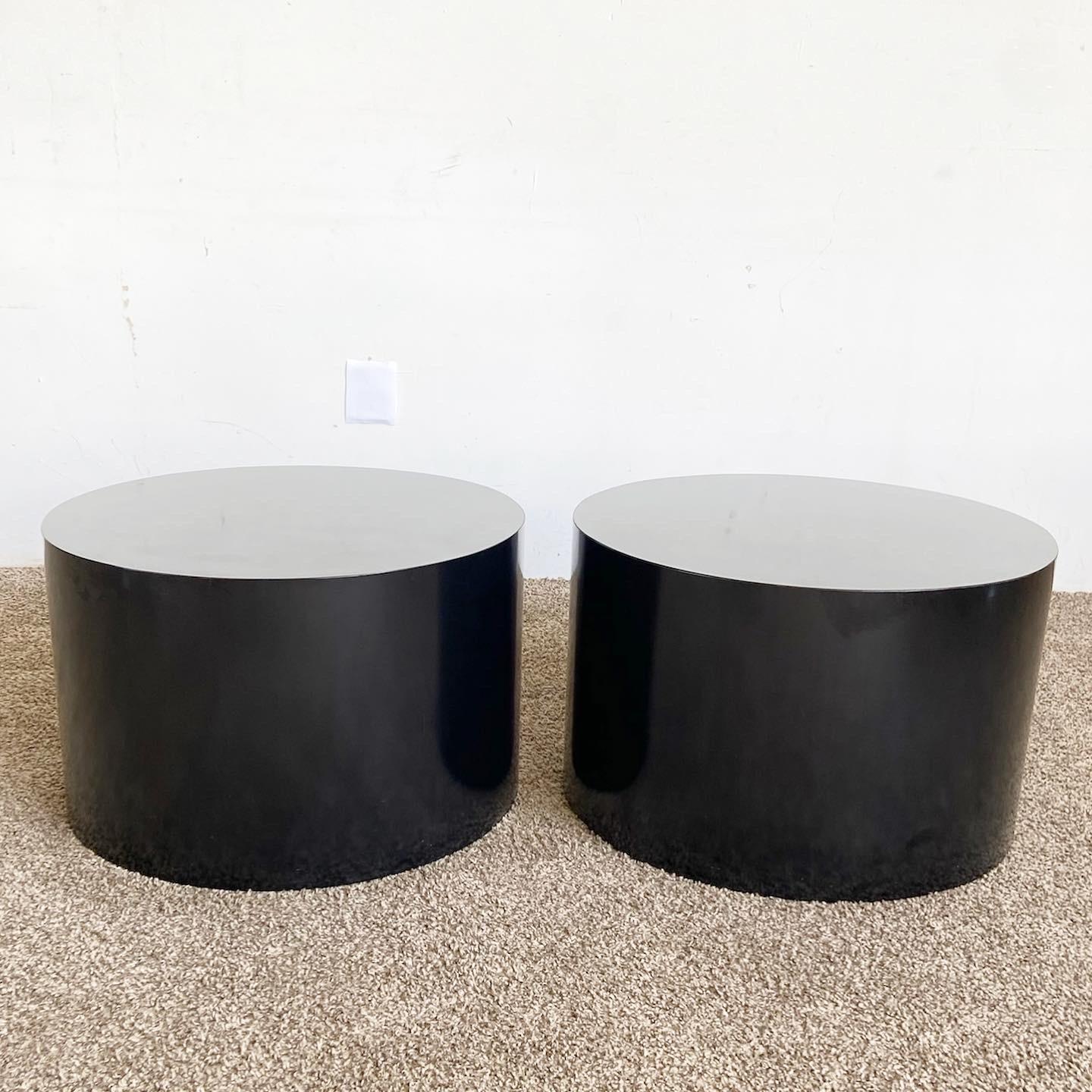 Our Postmodern Black Lacquer Laminate Drum Side Tables are a sleek addition to any home, featuring a high-gloss finish and unique drum shape.

Features a bold, black lacquer laminate finish, offering high-gloss appeal.
Unique drum shape adds an