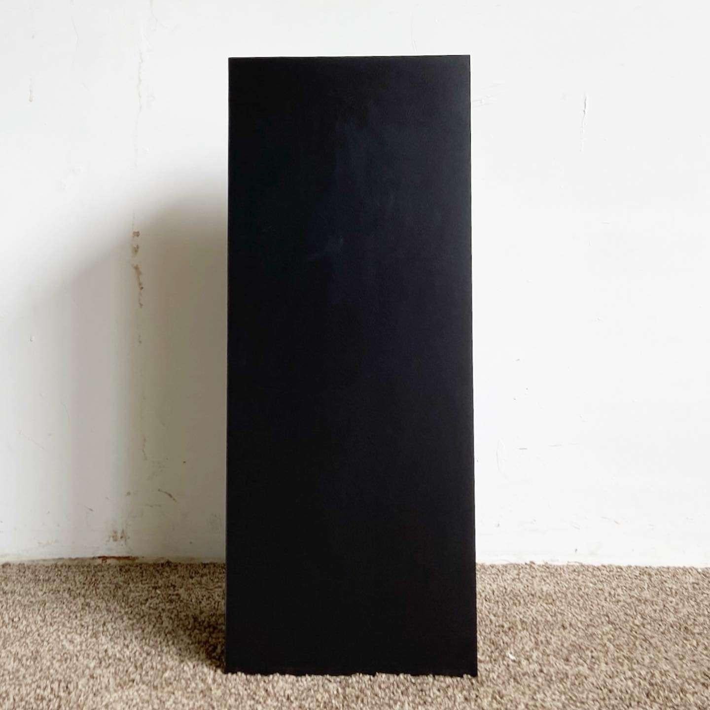 Wonderful vintage postmodern square pedestal. Features a black matte laminate through the rectangular prism’s surface.
