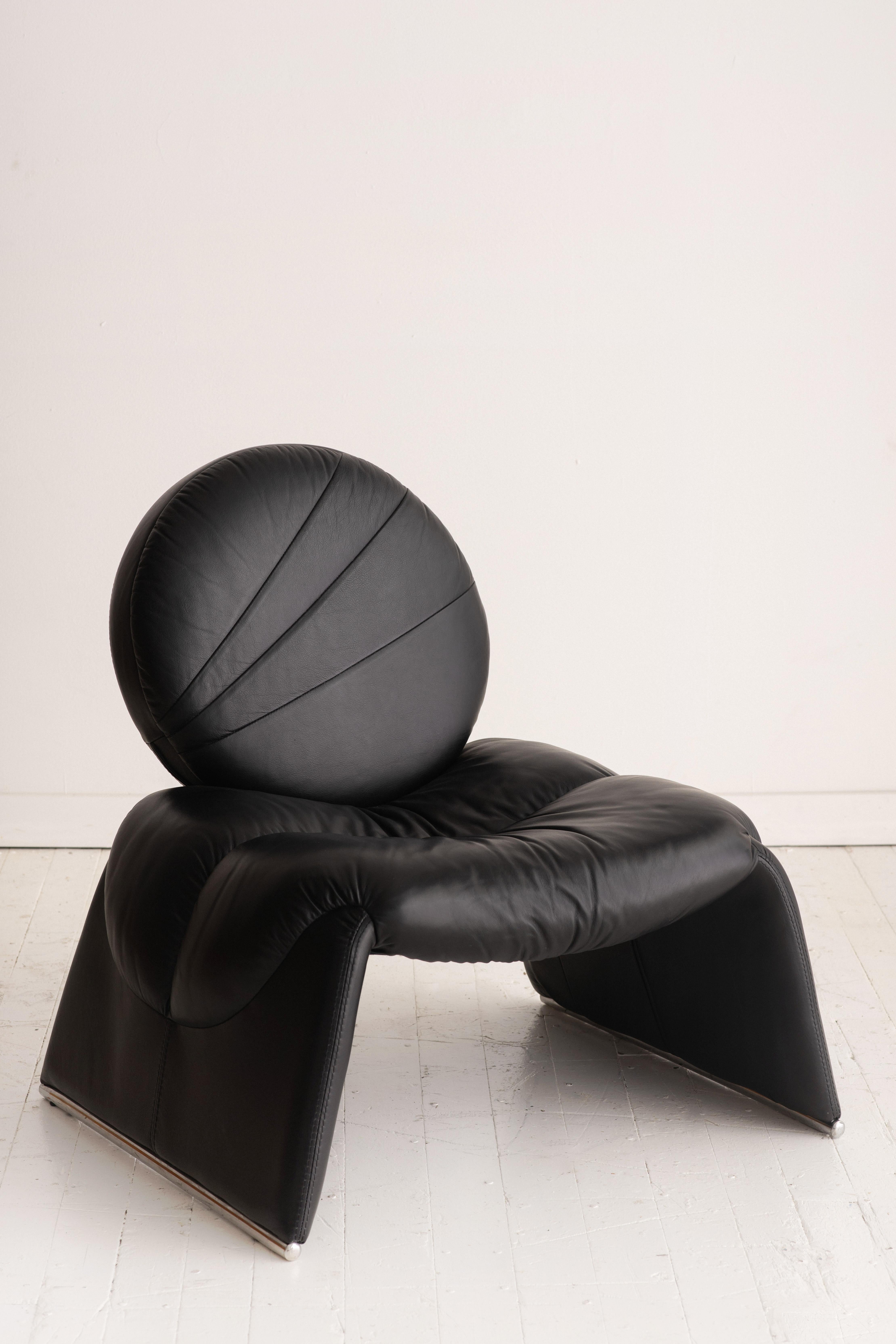Black leather “Calypso C35” chair by Vittorio Introini. Circle back on waterfall seat and chrome feet. Soft supple leather and very comfortable! Made in Italy.