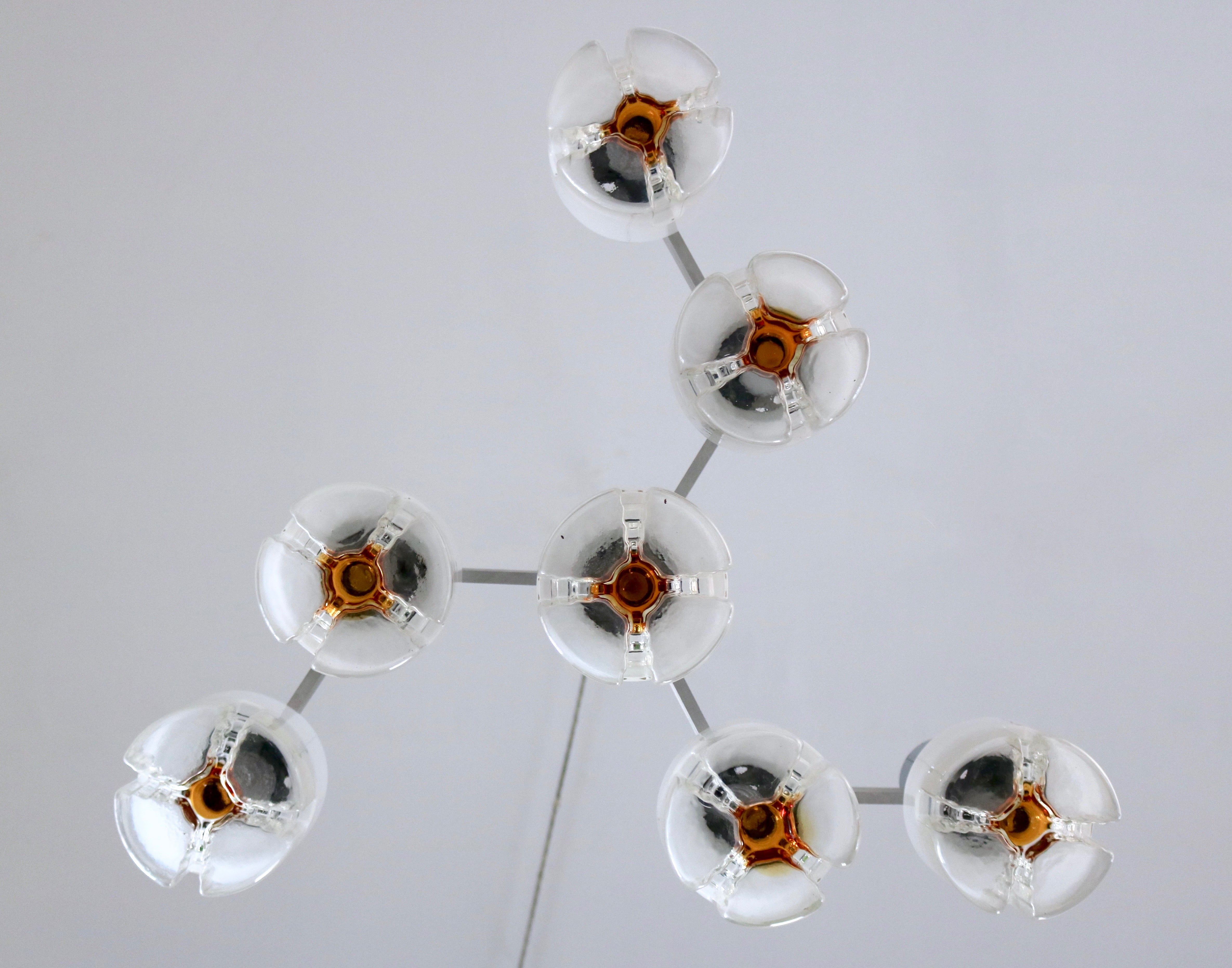 Made in Italy, 1970s.
This chandelier features a chrome-plated metal frame and seven Murano Glass diffusers.
It is a vintage piece, therefore it might show slight traces of use, but it can be considered as in perfect original condition and it is