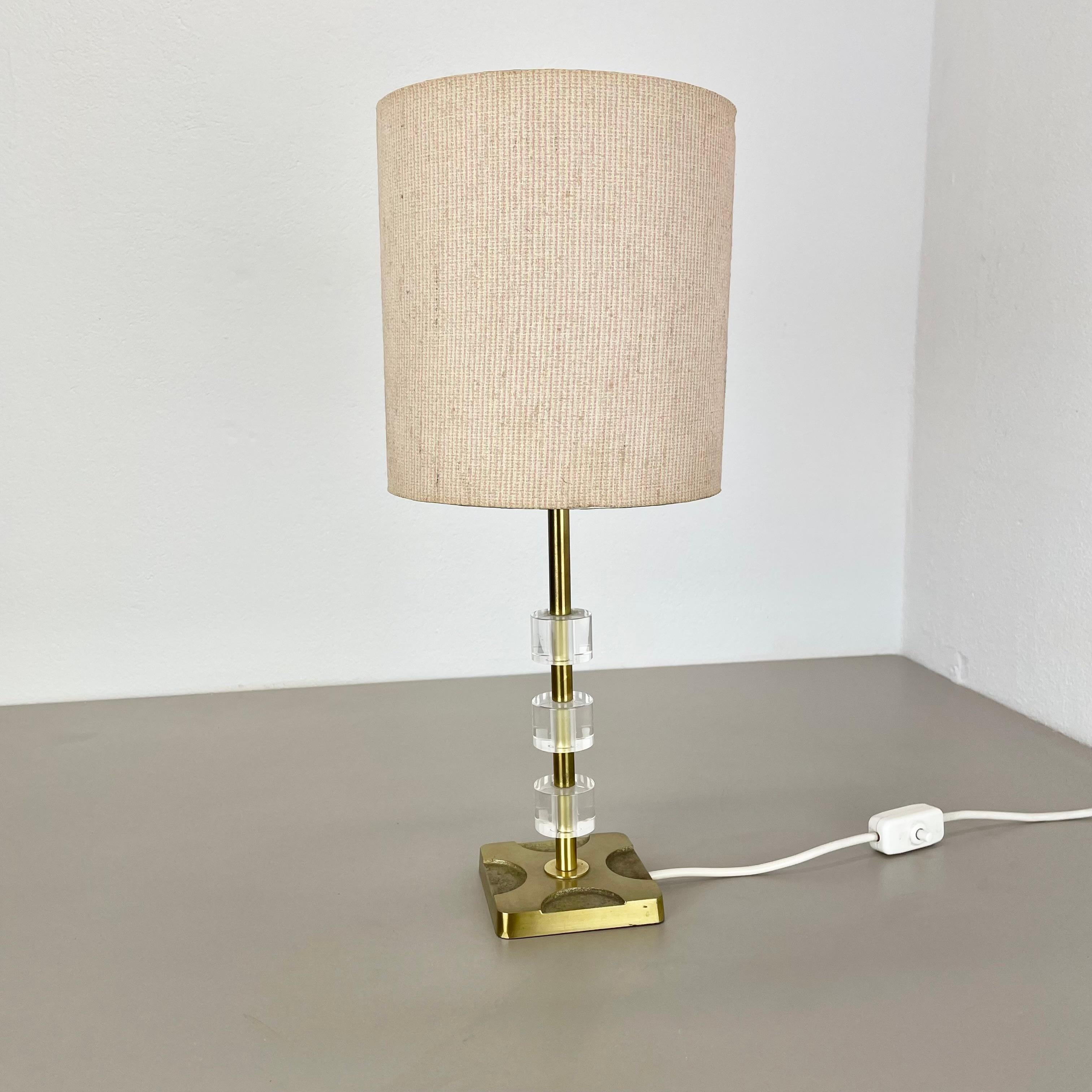 Article:

table light


Origin:

Italy



Age:

1970s



This vintage table light was produced in Italy in the 1970s in Italy. It is made of brass and acryl lucid glass. It features a very unique and unusual Brutalist postmodern cubic form with one
