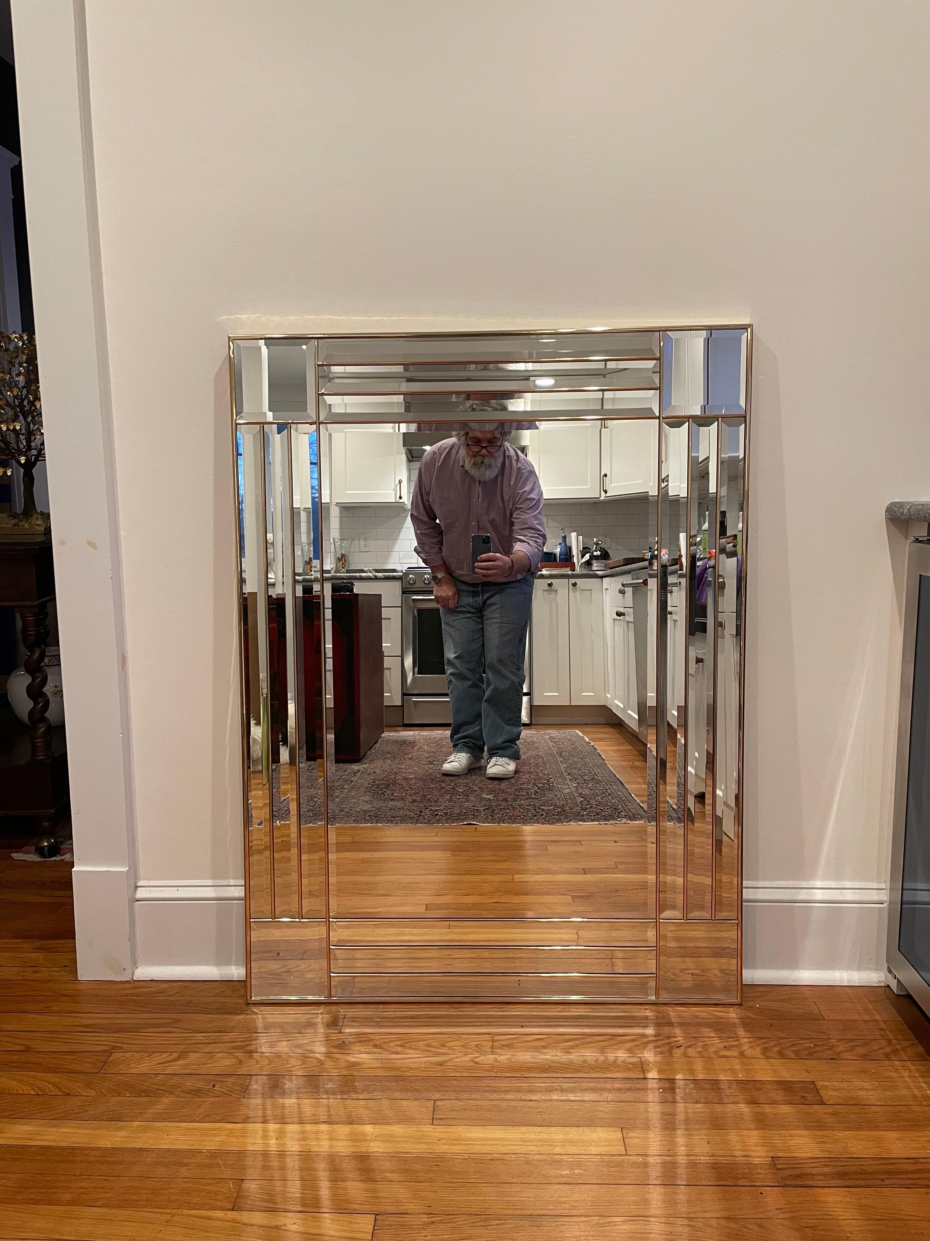 Striking Brass Mirror with Beveled Glass in a geometric panel design. Mounted on a heavy wood backing. Currently set to hang horizontally.