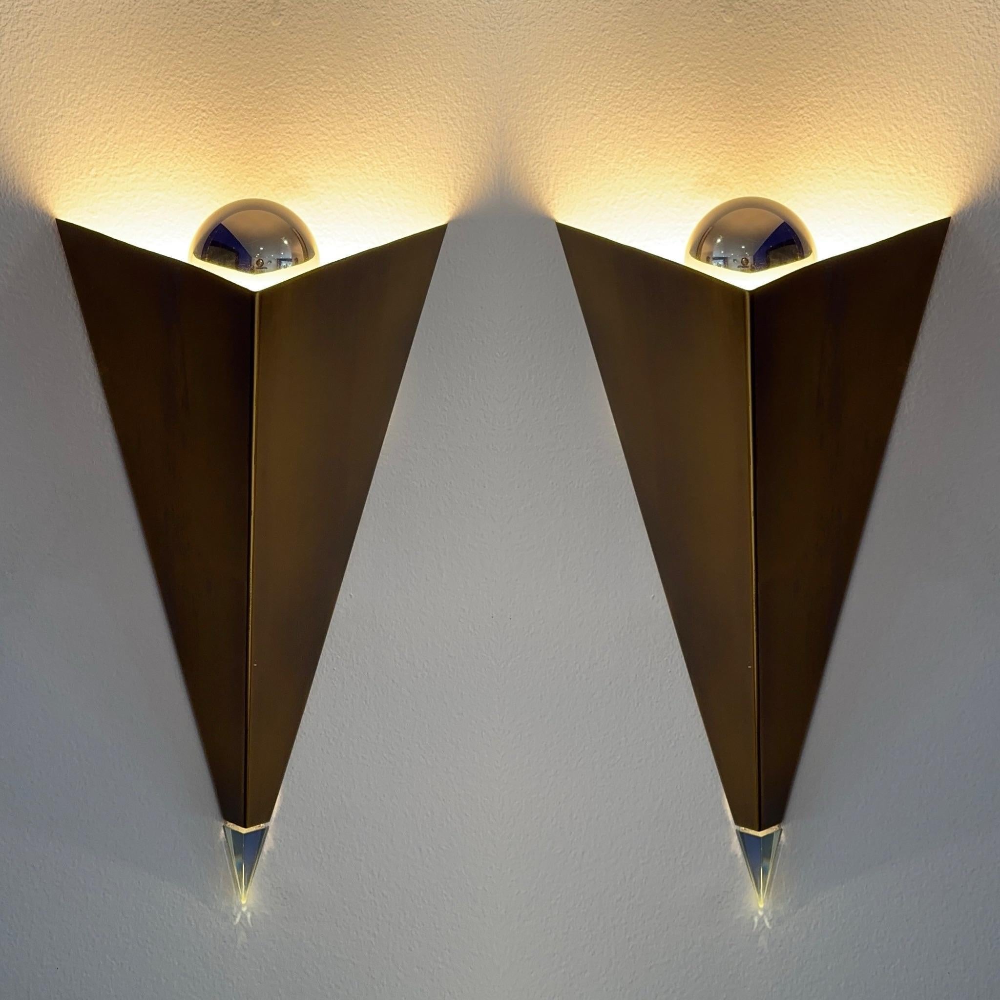 Late 20th Century designed in the postmodern idiom sconces. The pyramid body is finished in brass with a light green glass finial at the bottom of the pyramid and a chrome sphere inside the pyramid to diffuse the light. They are in mint condition