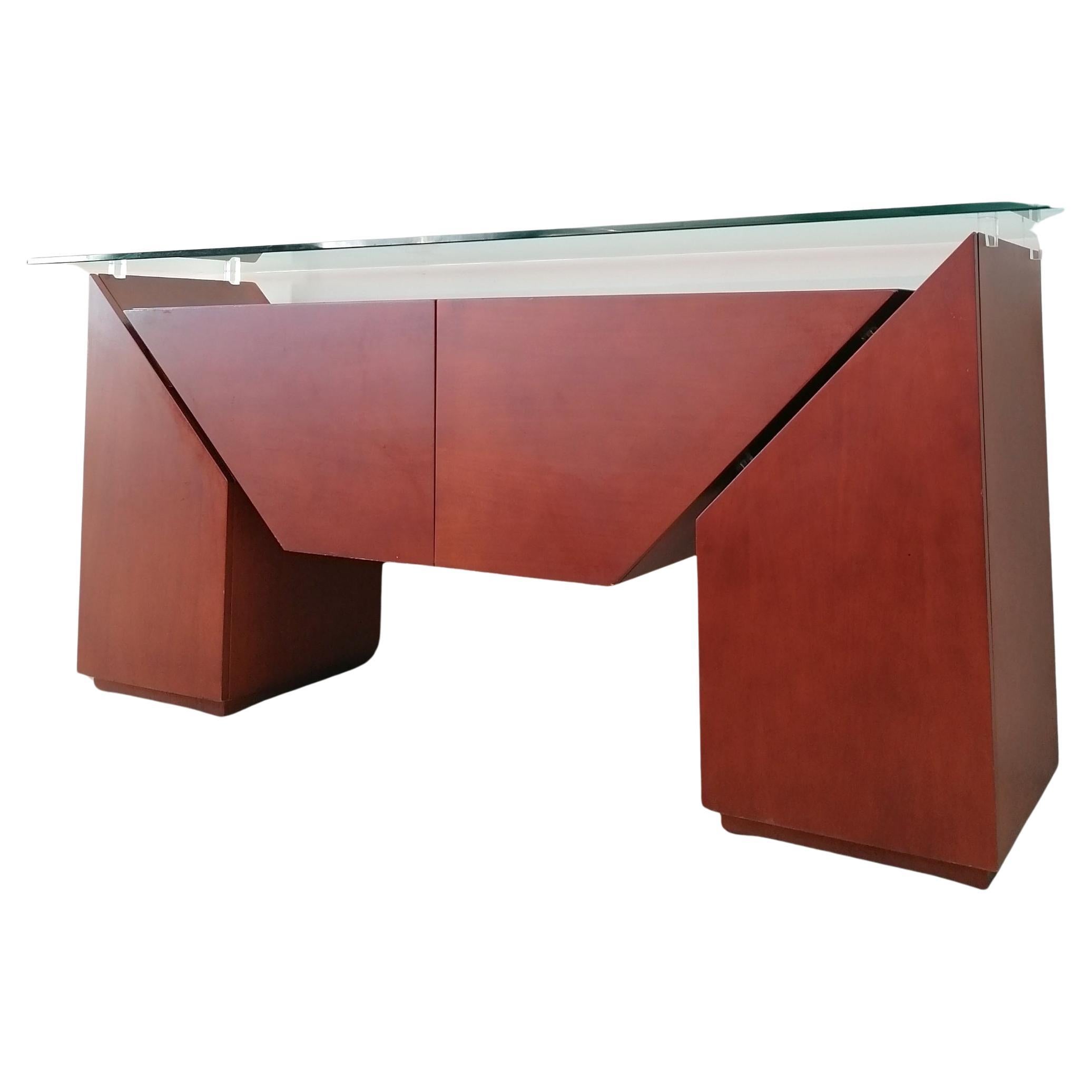 Postmodern 'Brooklyn' sideboard by Luigi Gorgoni for Roche Bobois, France 1980s.
Cherrywood veneer with a thick bevelled glass top. Lucite blocks support the top, and create gaps between the vertical and horizontal elements of the piece, giving the