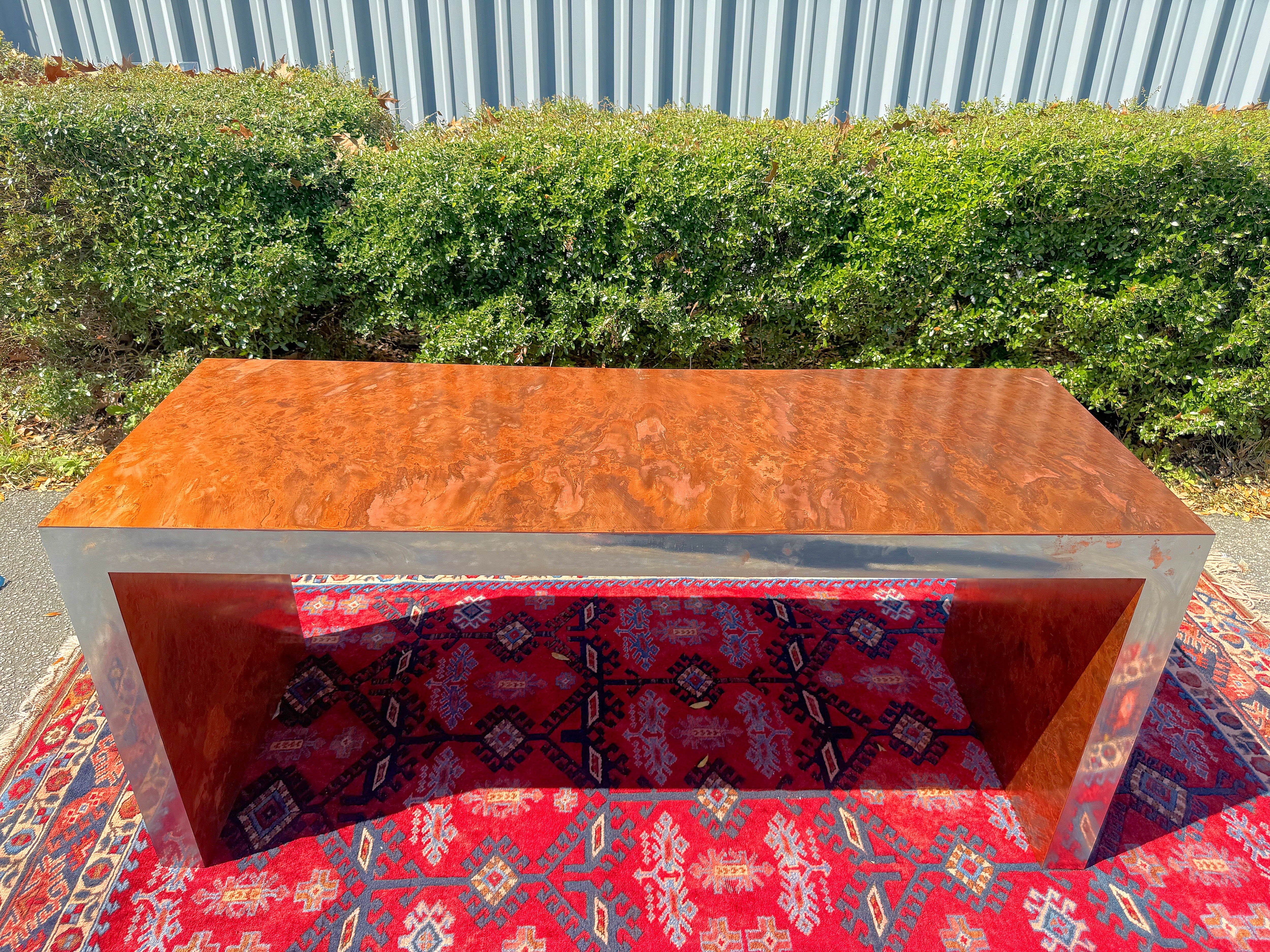 Postmodern Burled Copper and Chrome Parsons Style Desk/Console Table

Ok so I guess technicality this is a single drawer writing desk but I would use it as a console table.  So this desk has a mottled copper veneer that looks like Burlwood with