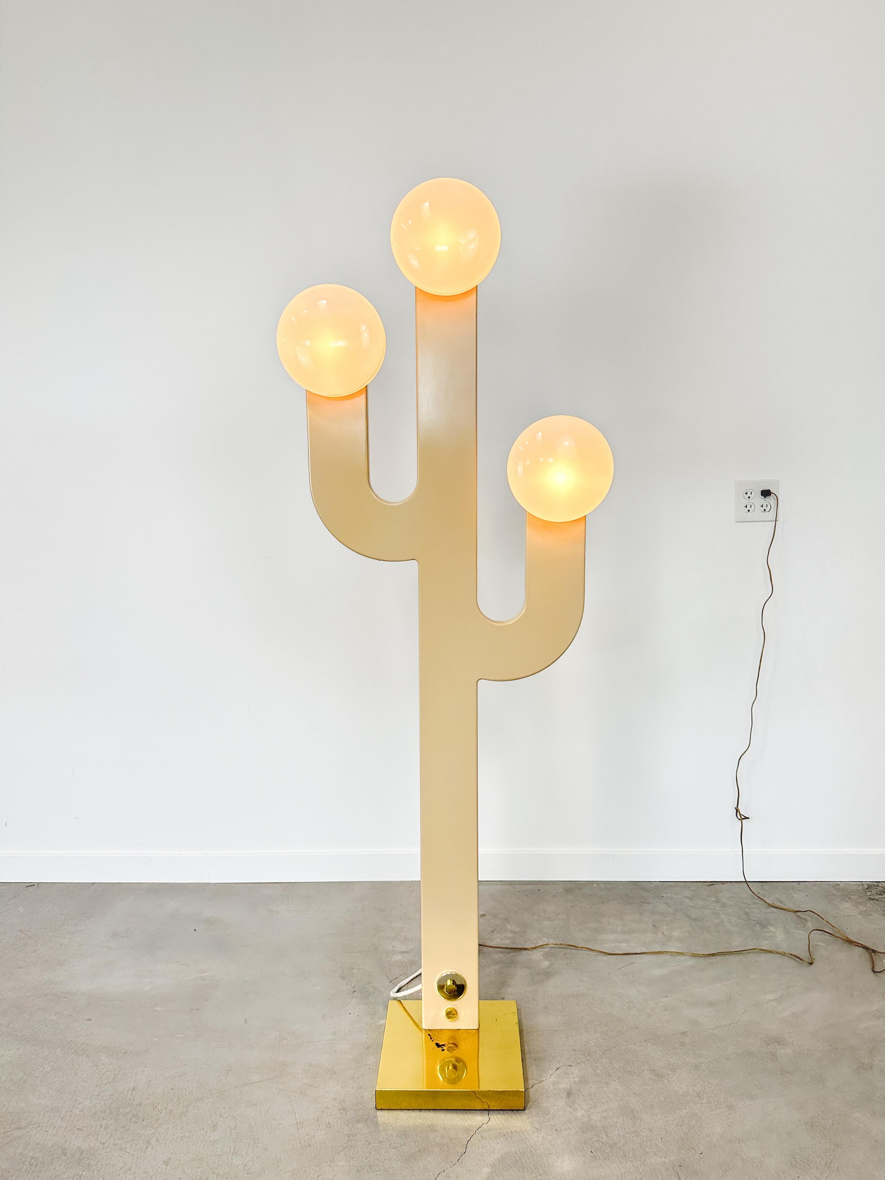 Bold, sculptural, and quietly playful, this rare 1980s cactus floor lamp turns lighting into a design moment. With its matte champagne finish, glowing orb lights, and structured silhouette, it captures the spirit of postmodernism with a surprising