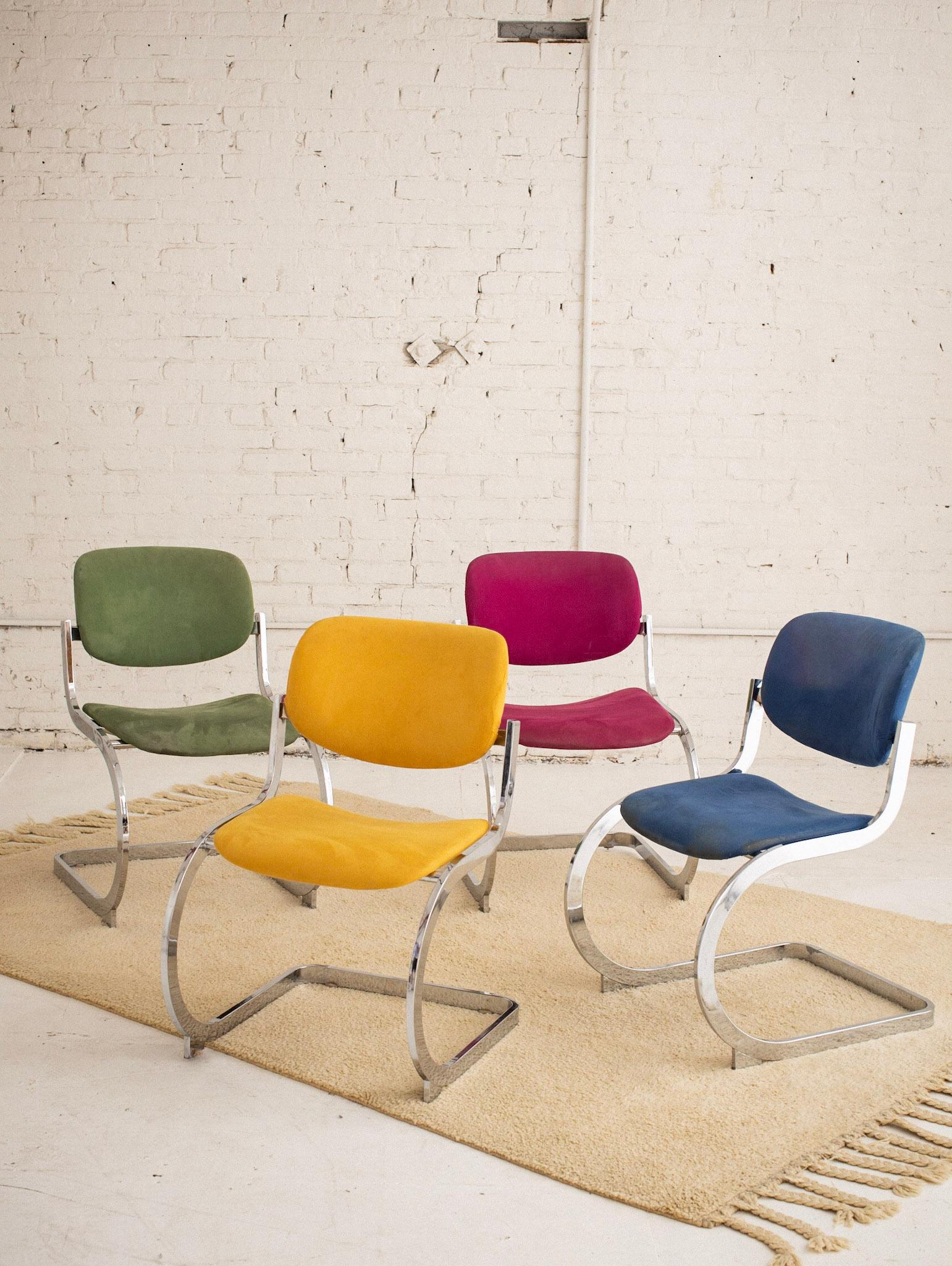A set of four postmodern chrome dining chairs by the Design Institute of America. Original microfiber upholstery featuring four complimentary color ways. Retains original DIA tags and serial numbers.