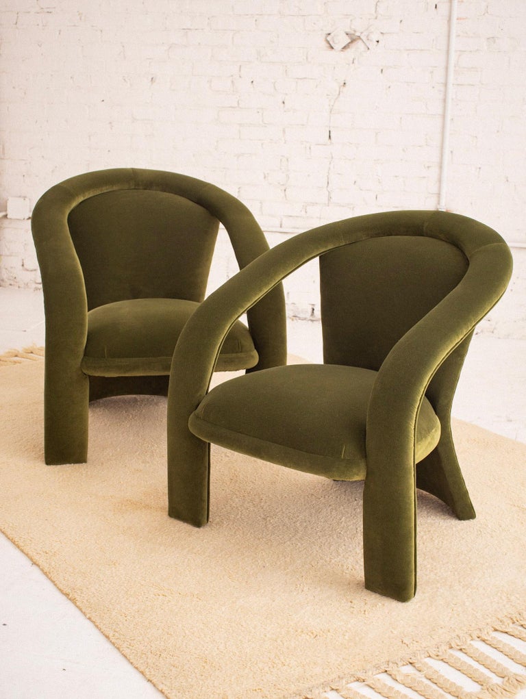 Pair of Postmodern armchairs by Carson’s. Newly reupholstered in green velvet. Flat curved back with sculptural arm detail.