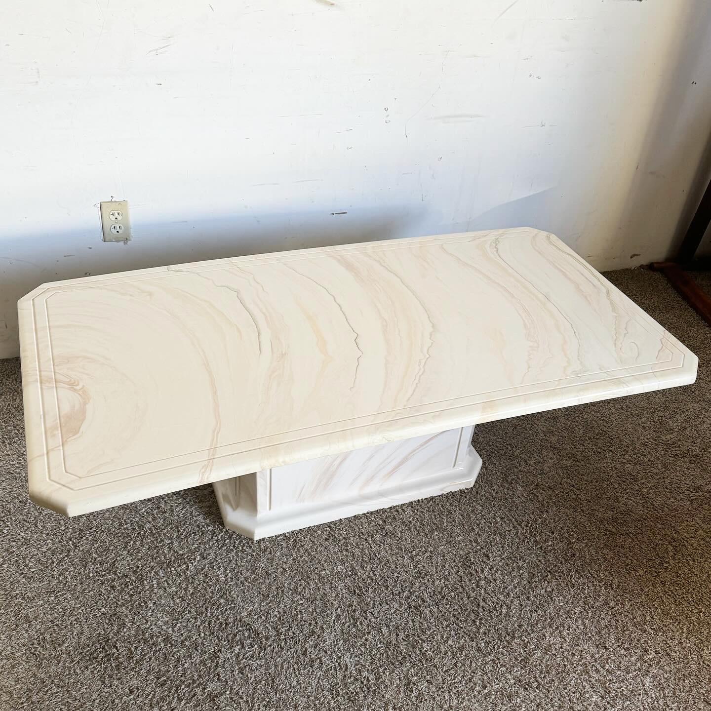 Step into the bold world of postmodern design with this Postmodern Cast Faux Marble Rectangular Coffee Table. Featuring a sophisticated faux marble finish, this table combines luxury with innovative design. The sleek lines and rectangular shape