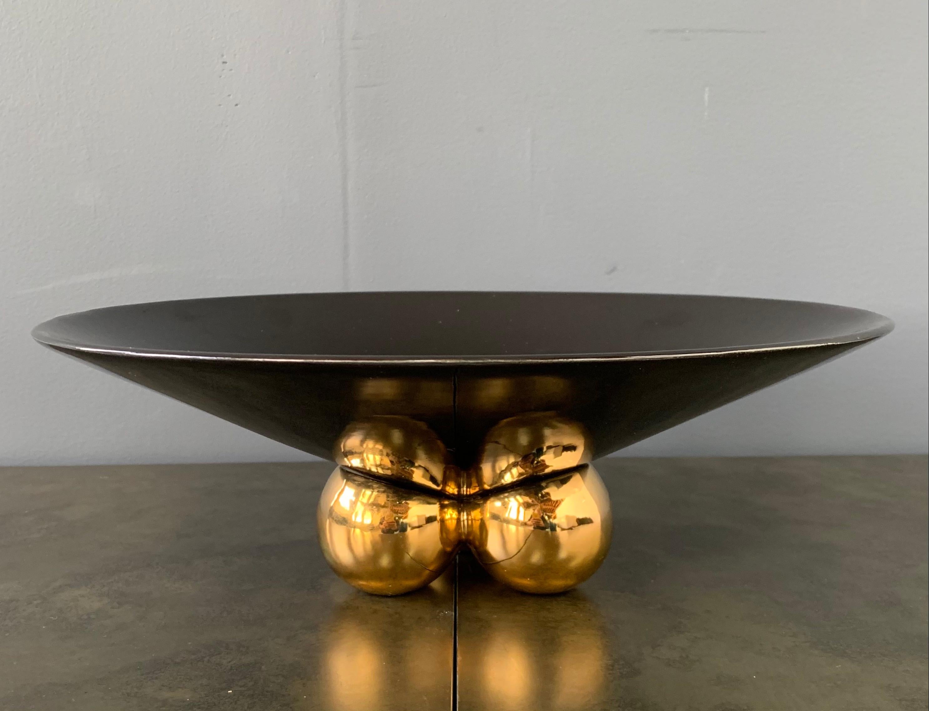 Large ceramic centerpiece by Jaru. It has the Classic black bowl with 3 gold spheres on the base. Simple clean design.