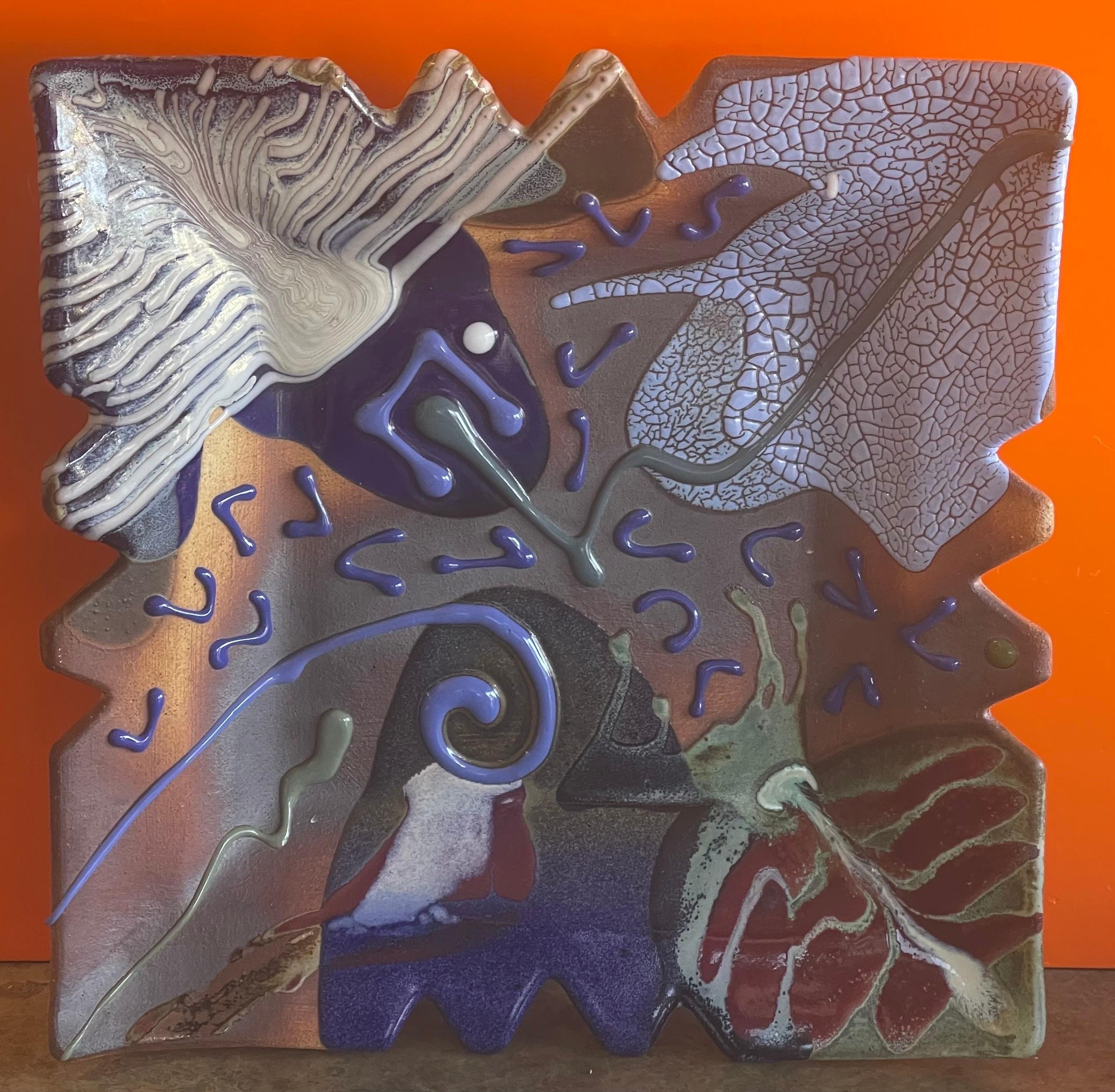A finely decorated postmodern studio pottery ceramic wall sculpture by Seattle potter Matthew Patton, circa 1990s. Potter is known for his dramatic glaze effects and texture used on this ceramic creations. The piece has a complex surface decoration