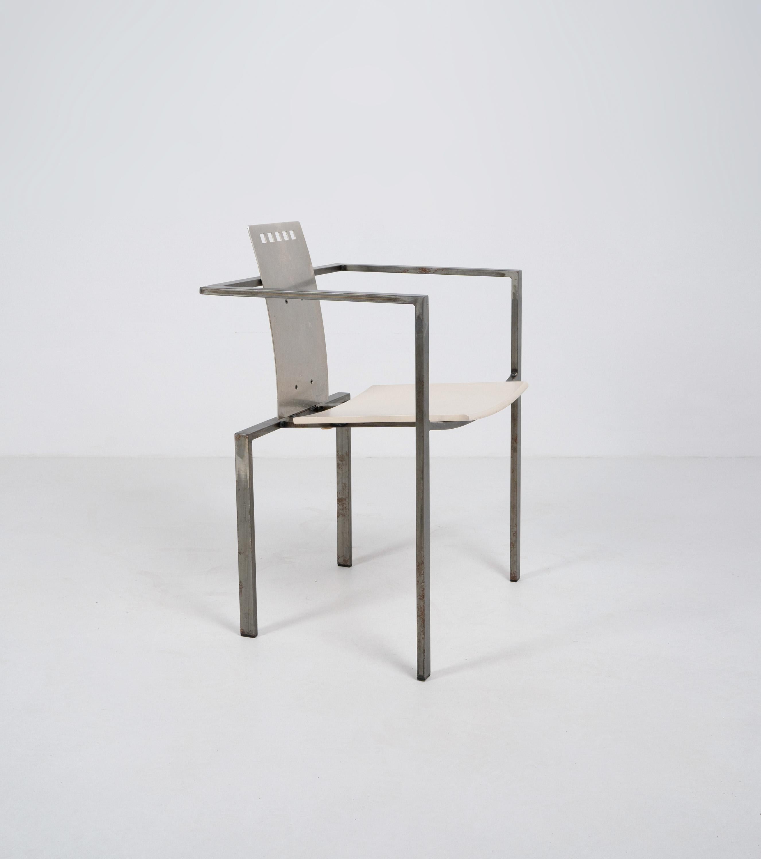Postmodern steel chair designed by Karl Friedrich Förster. Composed of a tubular steel frame and bent steel sheet back rest with square laser cut detailing and an off white painted plywood seat. 

Dimensions (cm, approx): 
Height: 83
Width: