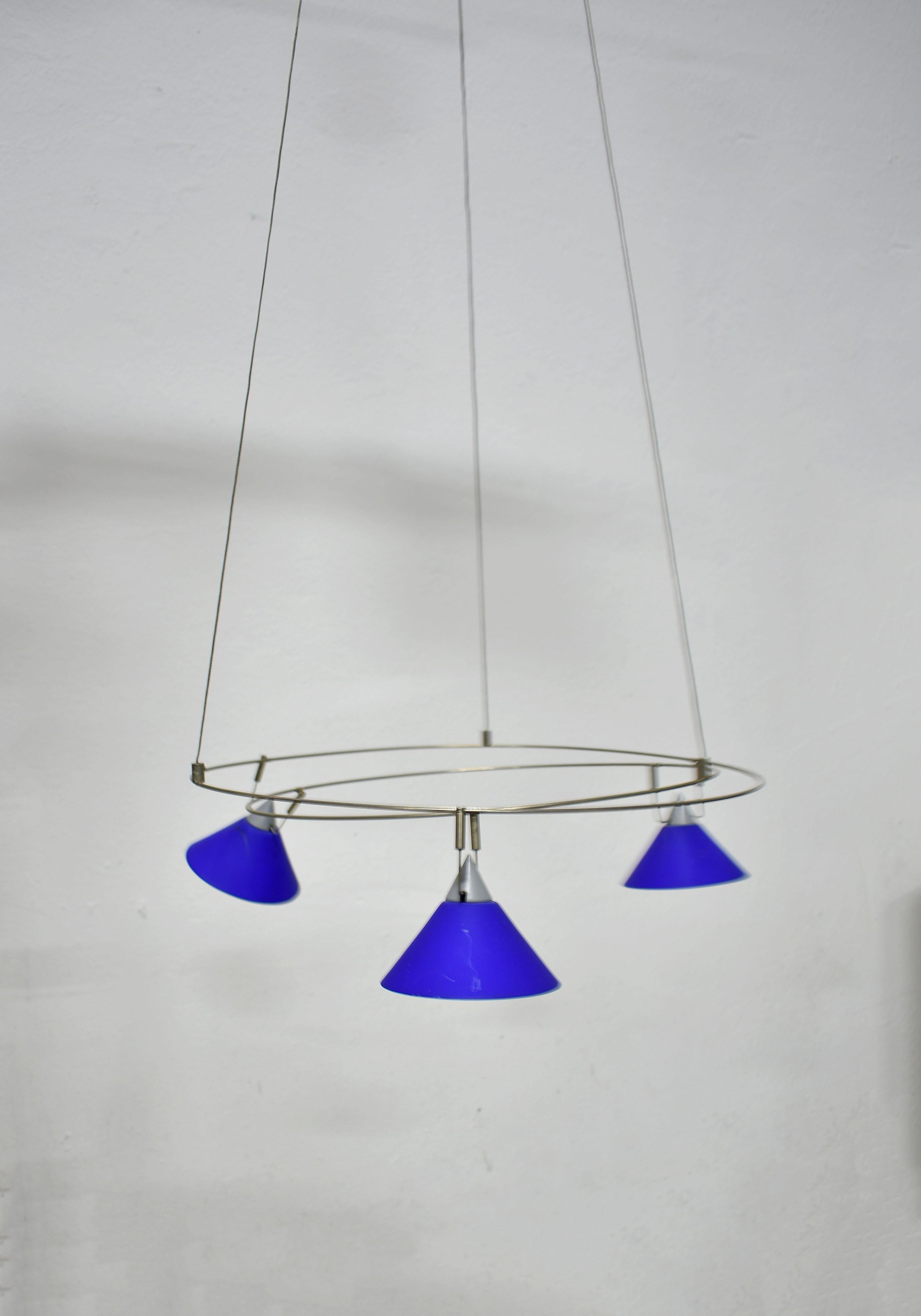 Minimalist chandelier from the postmodern era, Germany, 1980s

Unknown manufacturer and designer

This elegant minimalist chandelier features a large metal ceiling rose with an adapter hidden inside and a light-weighted circular hanging
