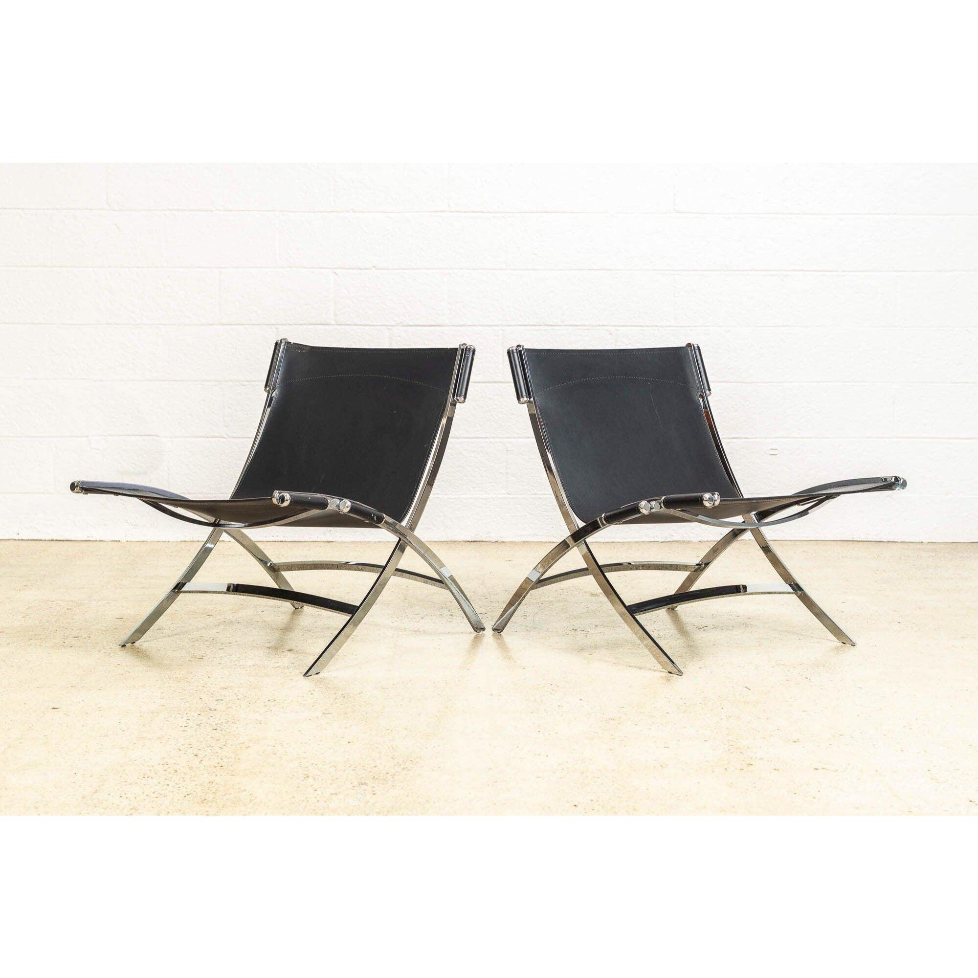 This exceptional pair of vintage Antonio Citterio for Flexform “Timeless” chrome & black leather lounge chairs are a sleek, postmodern interpretation of classic Mid-Century Modern style. Impeccably constructed, the chairs are heavy and substantial