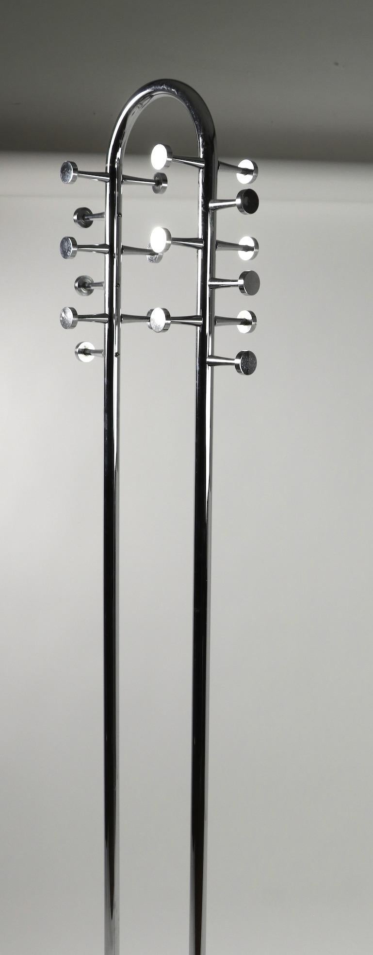 Postmodern chrome coat tree, hat stand having a tall U-shaped vertical standard with 18 hooks, on disk form base. This piece is well constructed and was probably originally designed for commercial application, it is in good condition showing some