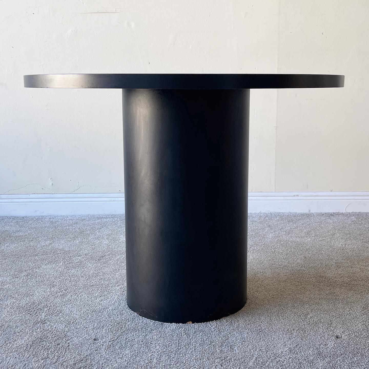 Stunning circular dining table with a black and white laminate.