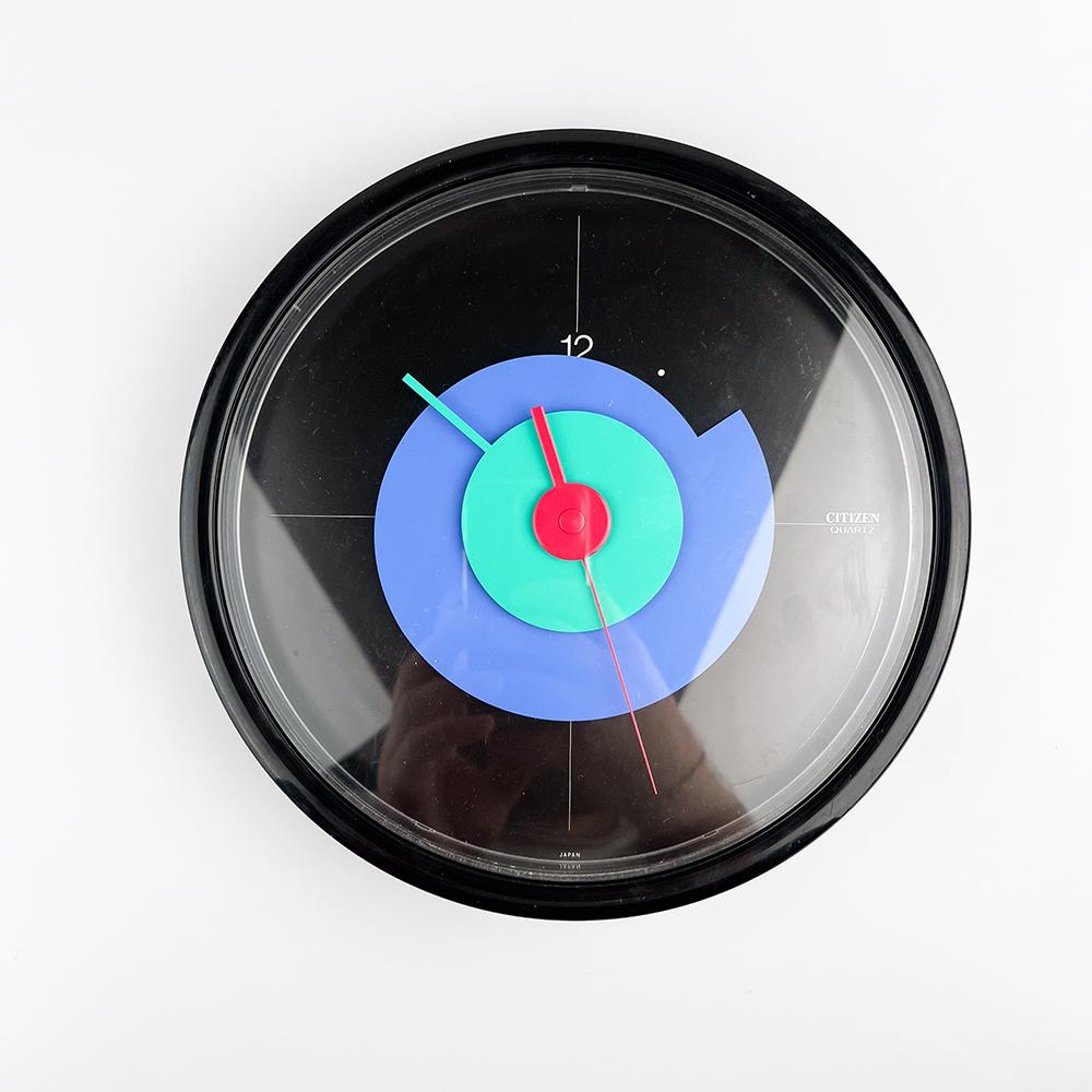 Postmodern Citizen Wall Clock, 1980's

Made in Japan. Black plastic. 

Working correctly. The rear starting system works by moving the tab from start to stop and back to start to start.

Measurements: 25x3 cm.
